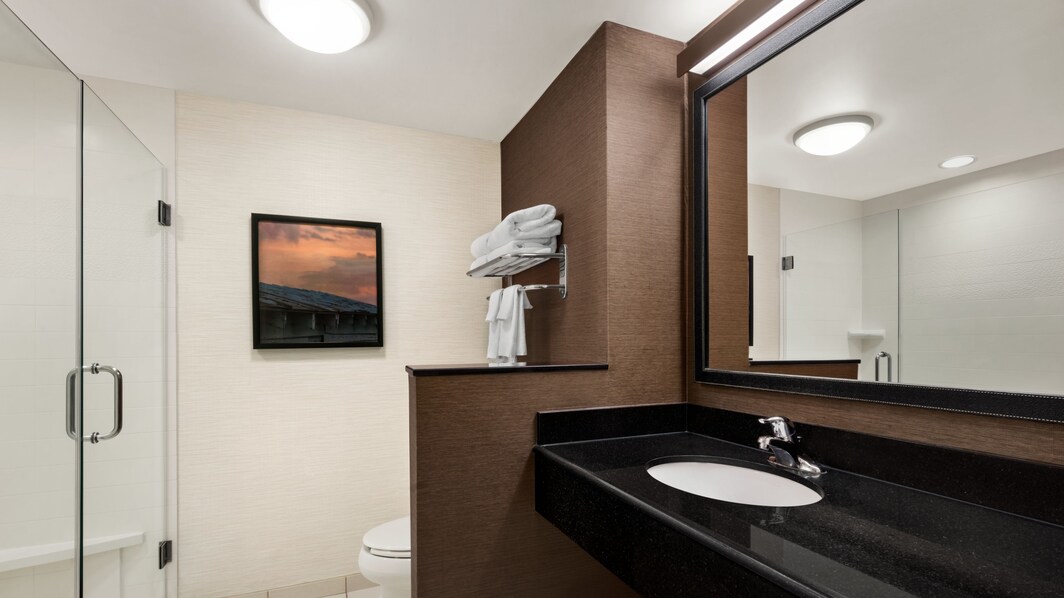 Guest room bathroom showing sink, shower, toilet. 