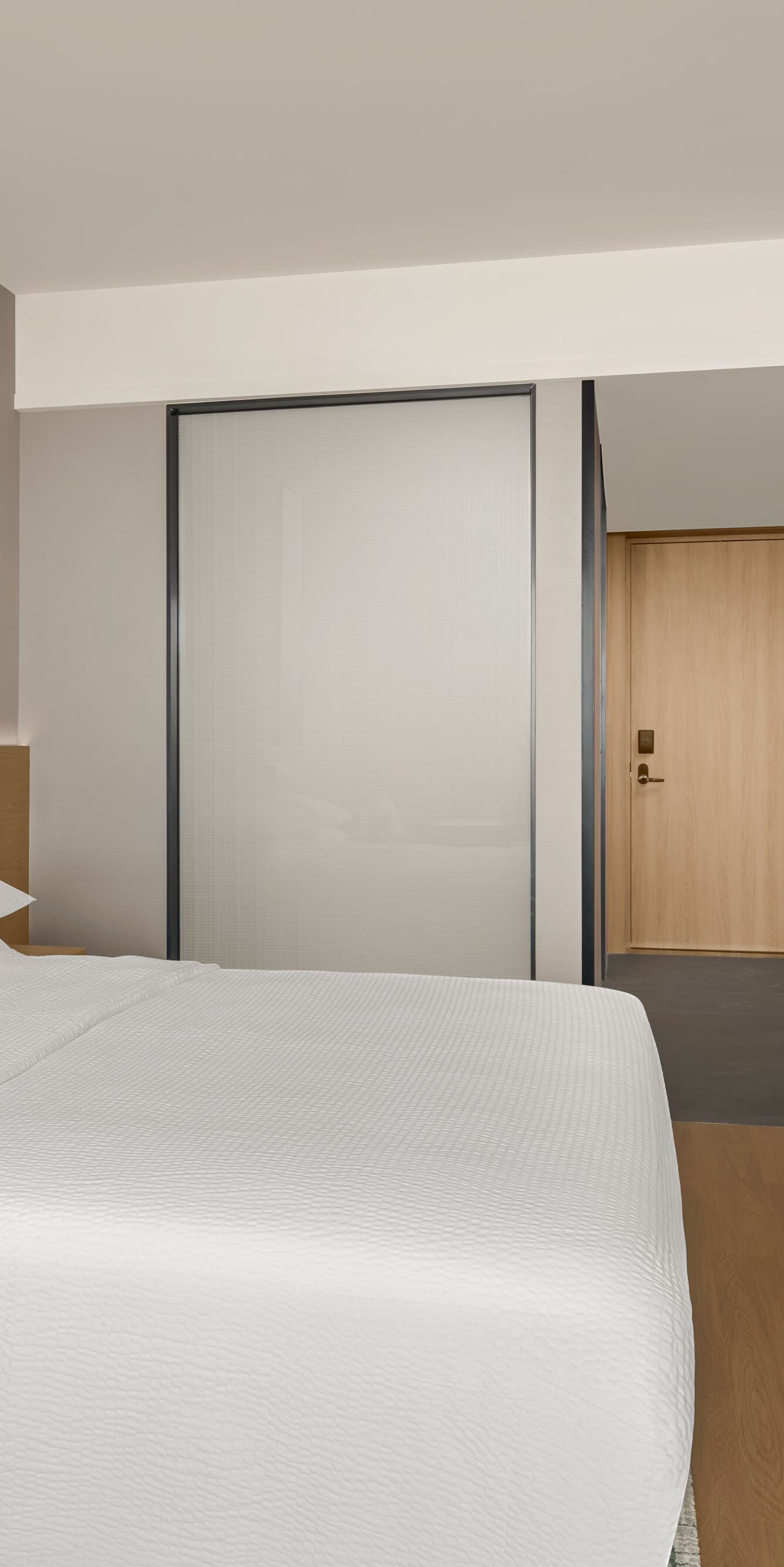 King bed with TV and wall-mounted desk