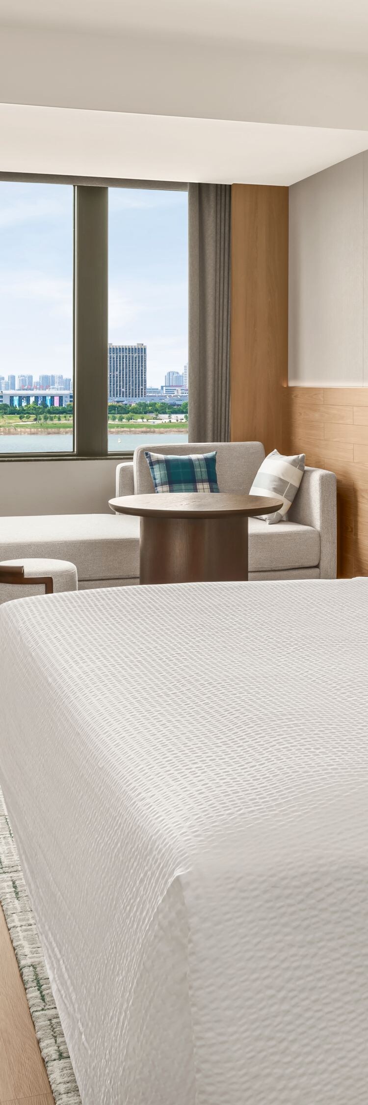 King bed with desk, chair, and window view