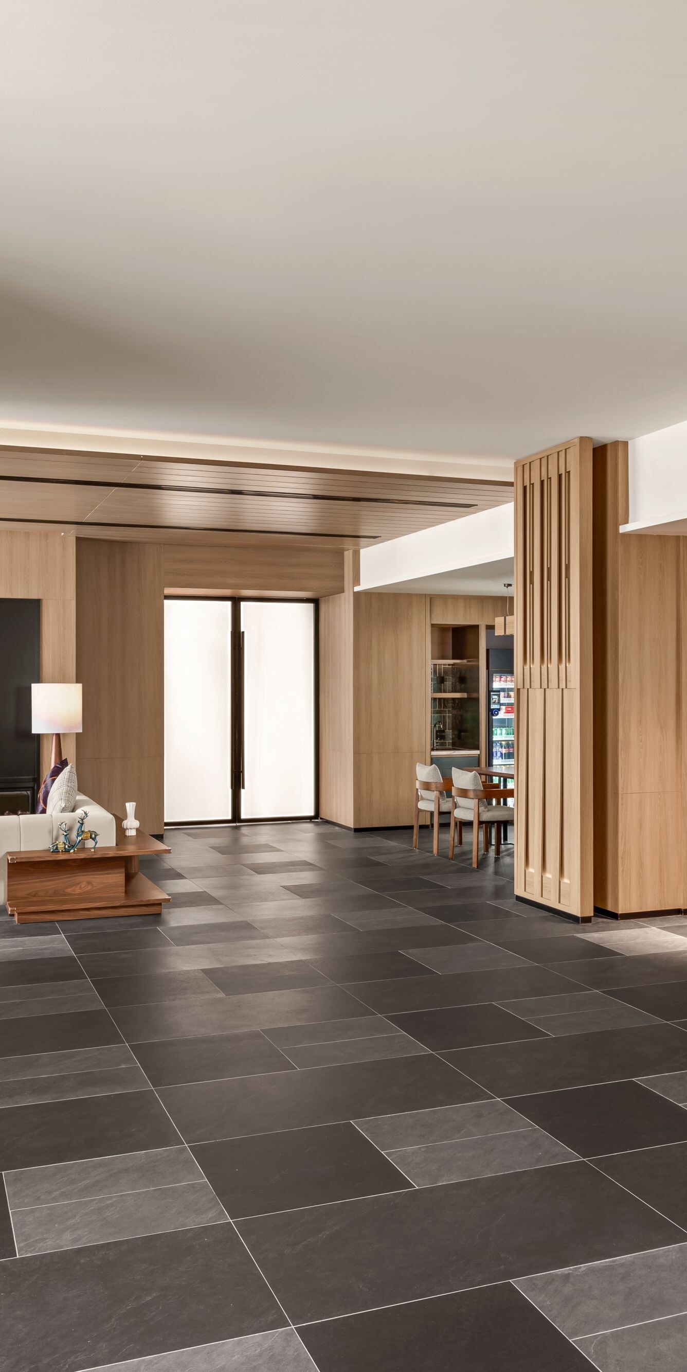 Lobby with seating area and wood panel accents