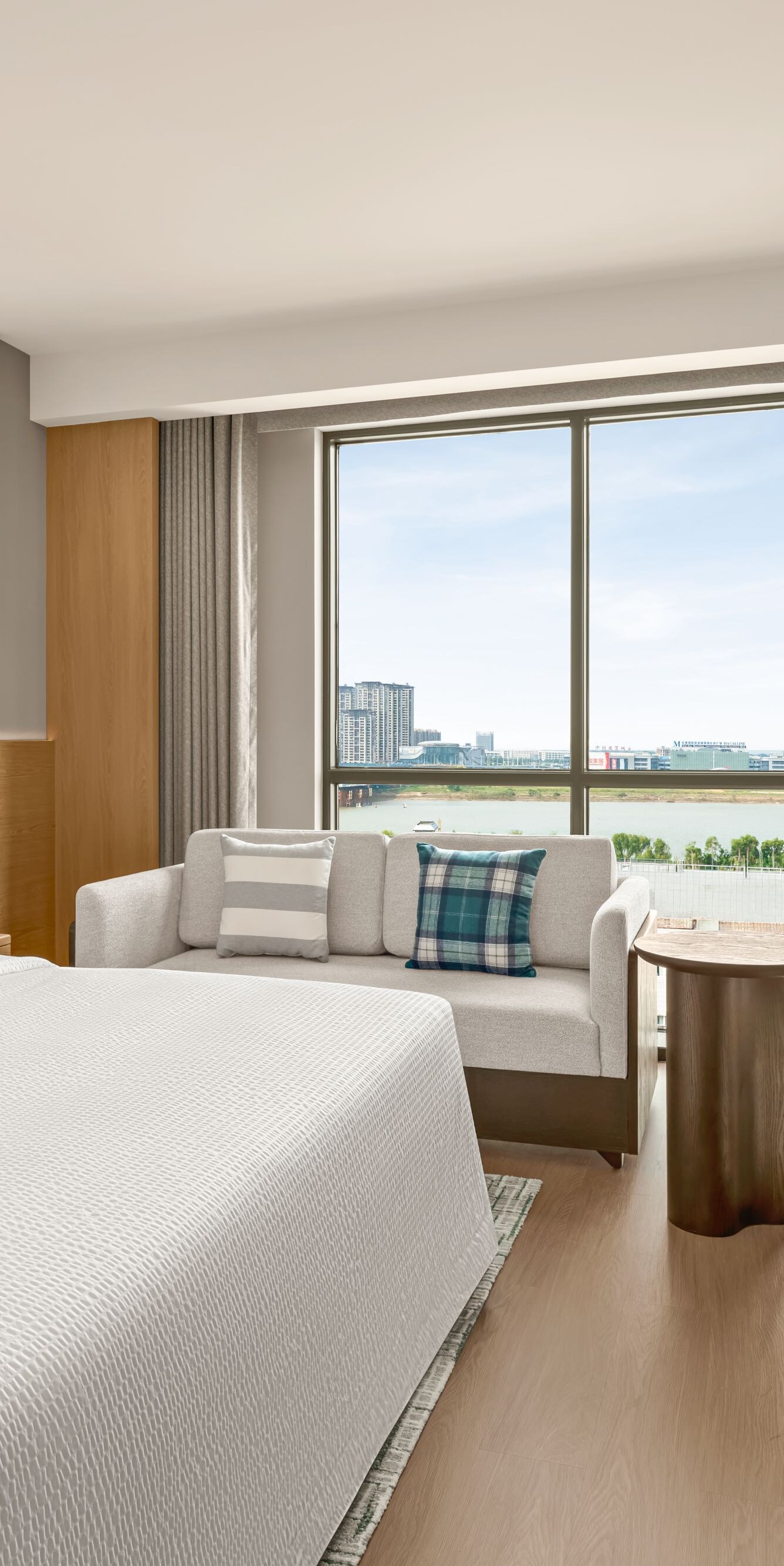 Suite bedroom with bed, sofa, and window view