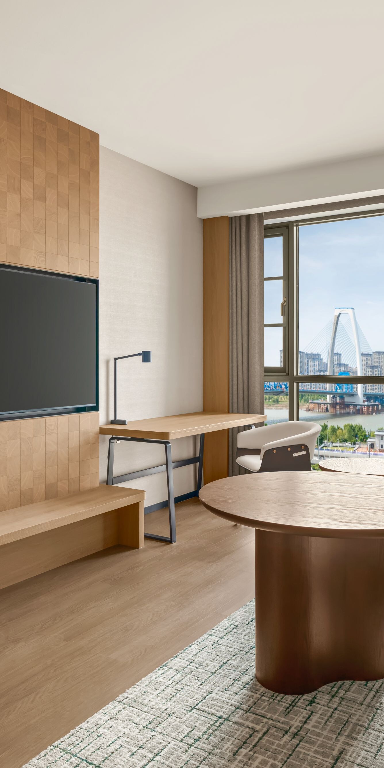 Suite living area with sofa, table, and TV