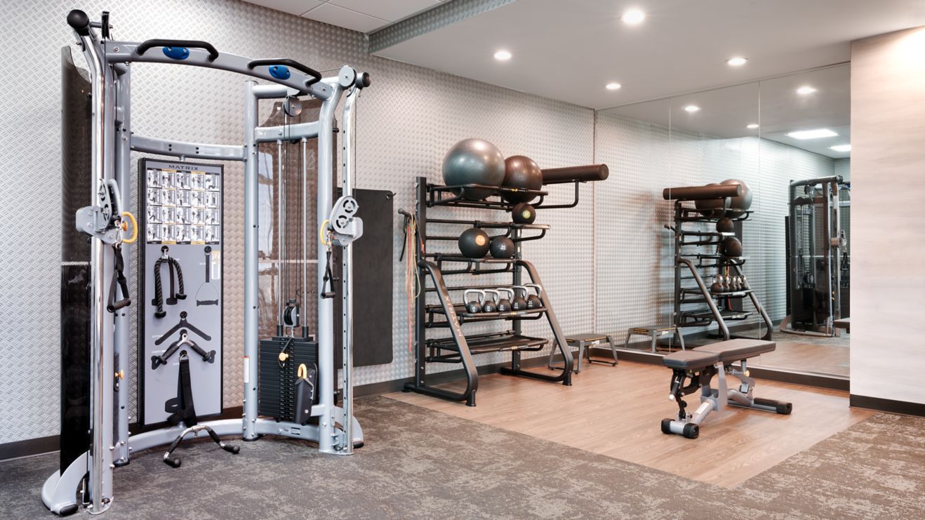 Fitness center with bench, machines, and equipment