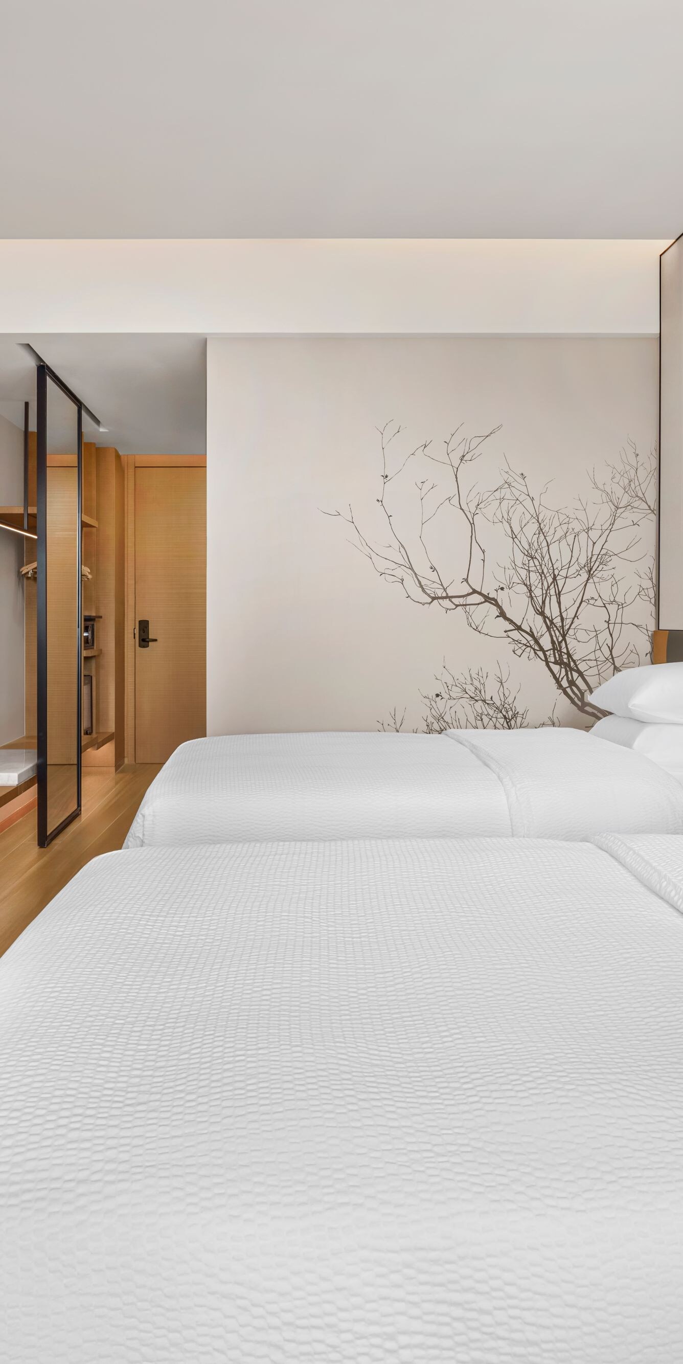 Two beds with TV and wall art