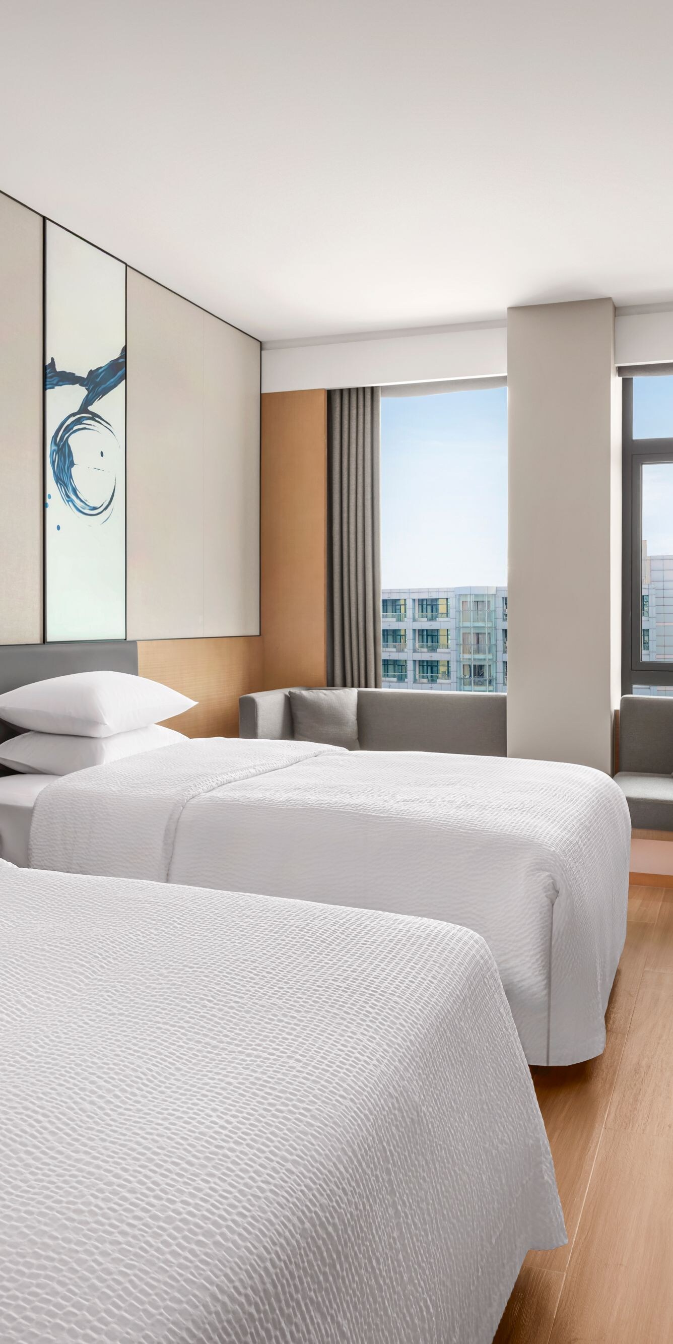 Two beds with table and window seating