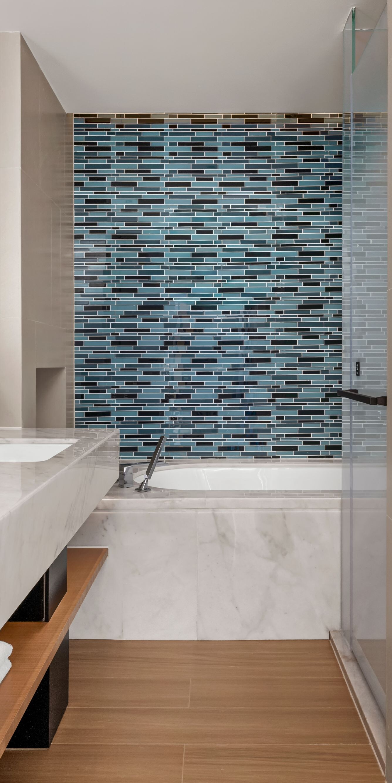 Suite bathroom with double vanity and bathtub