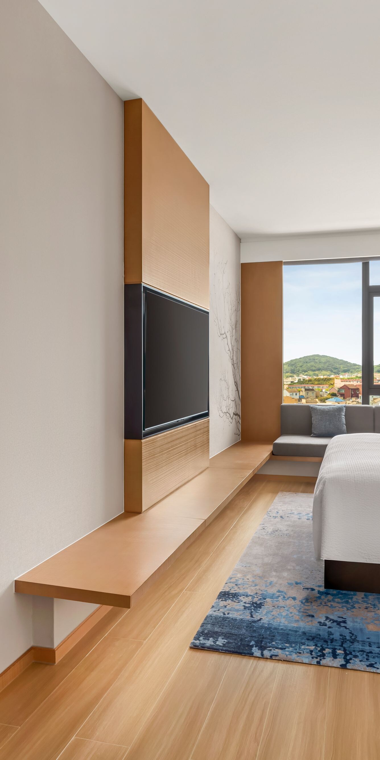 Executive suite with bed, chair, and TV