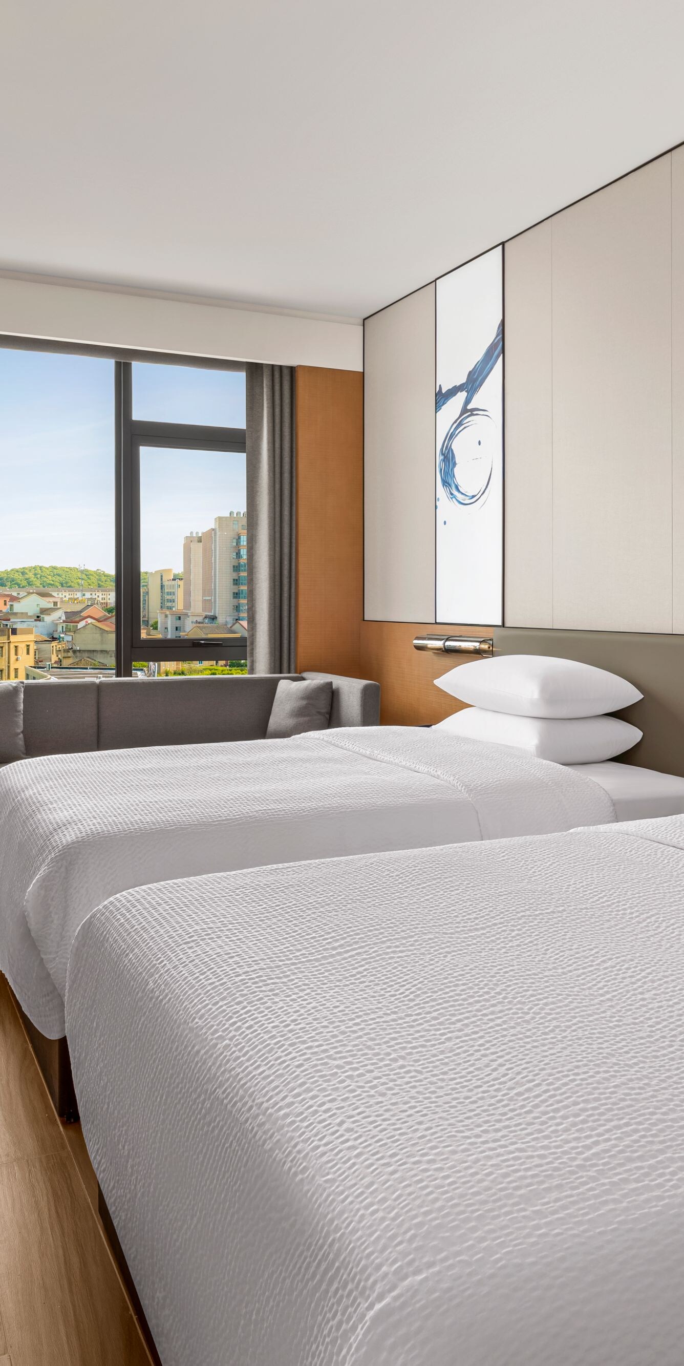 Two beds with window seat and TV