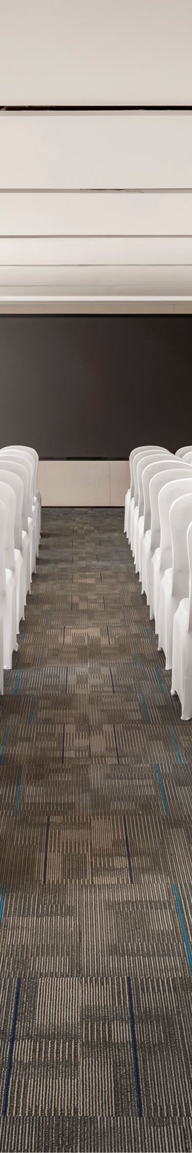 Meeting room with rows of chairs and screen