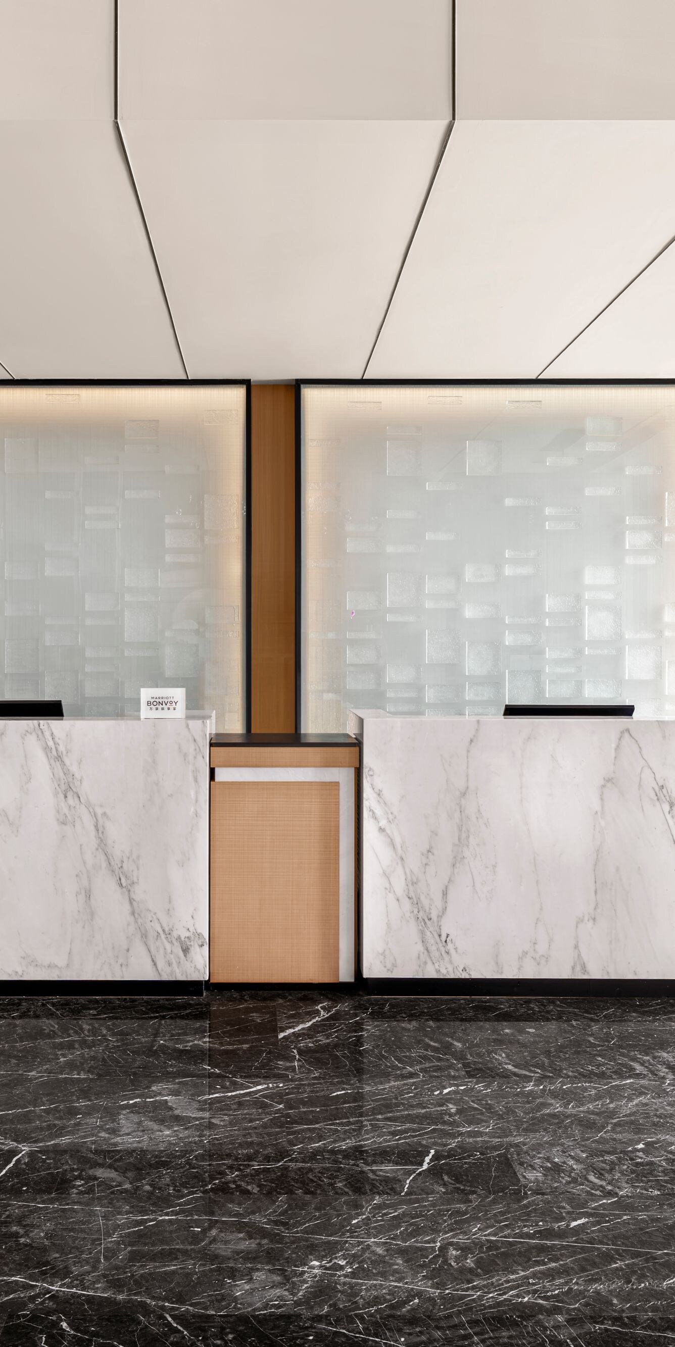 Reception desks with marble counters and windows