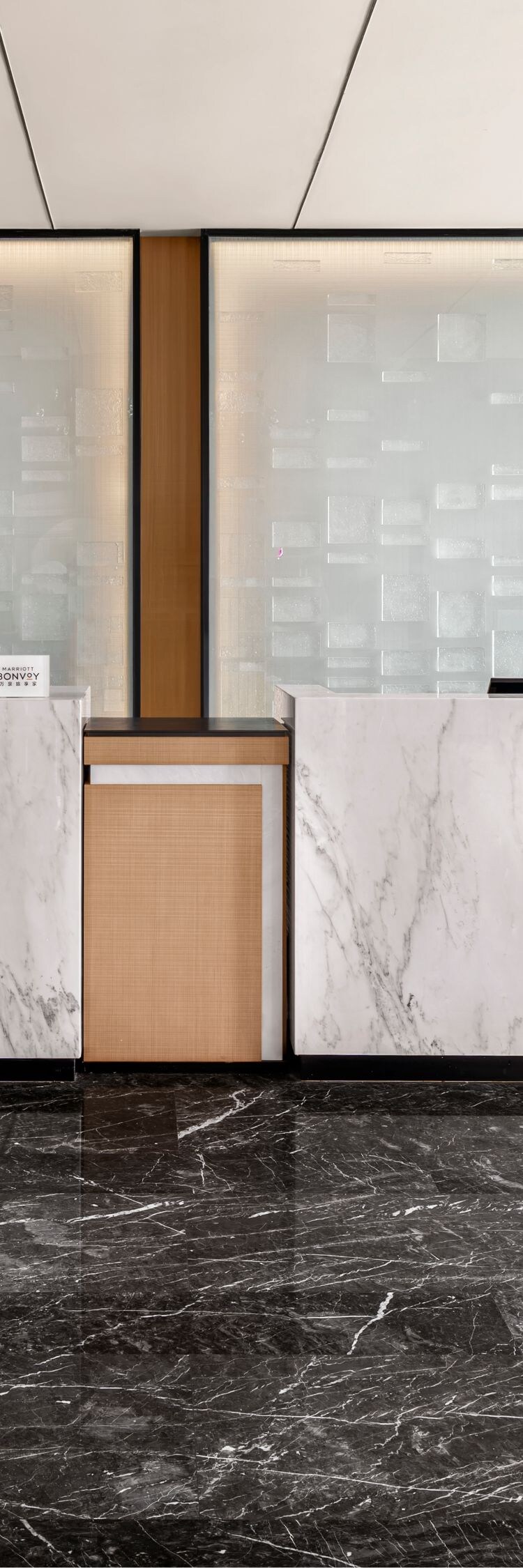 Reception desks with marble counters and windows