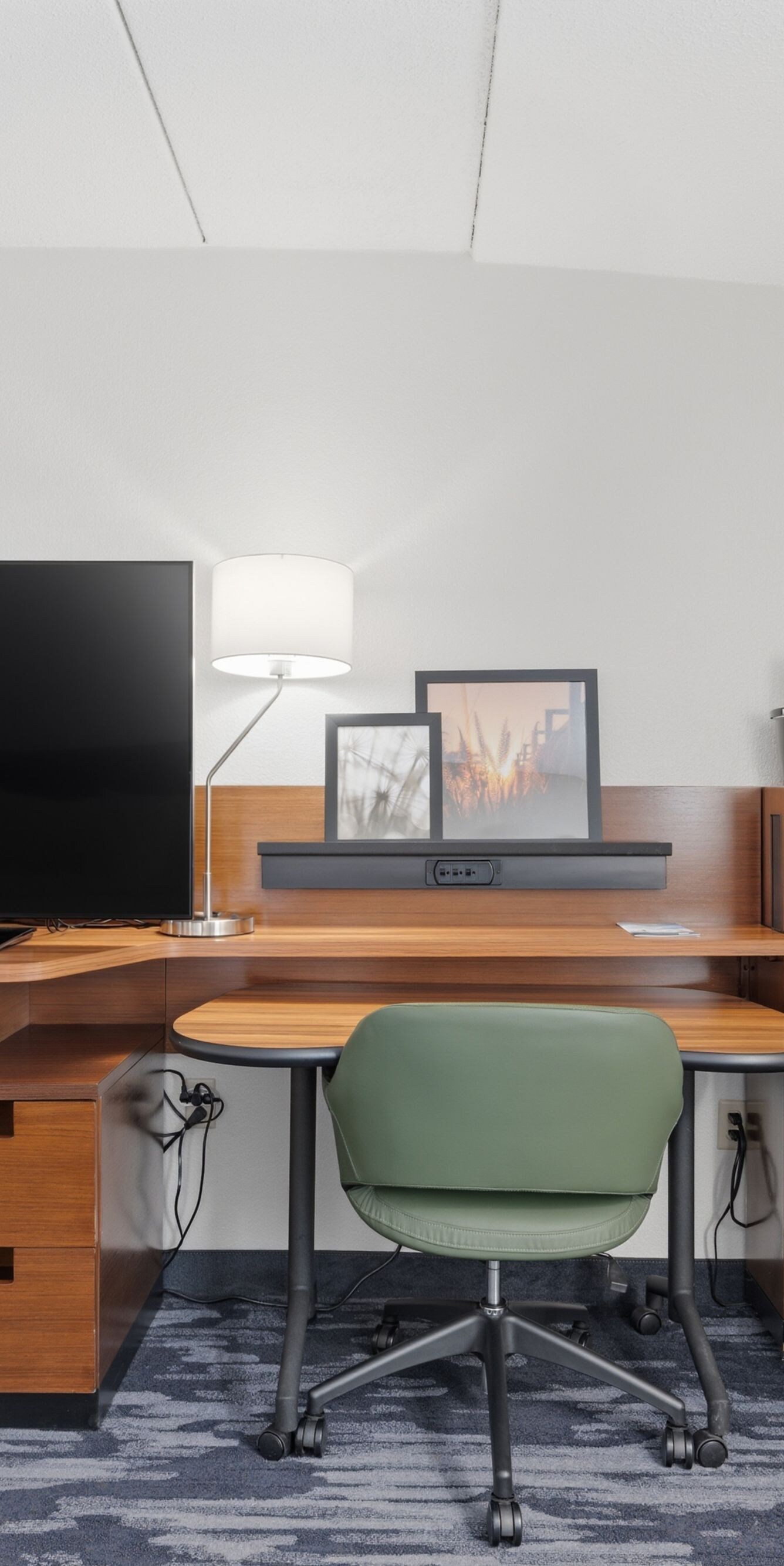 Large desk with tv, mini fridge and chair