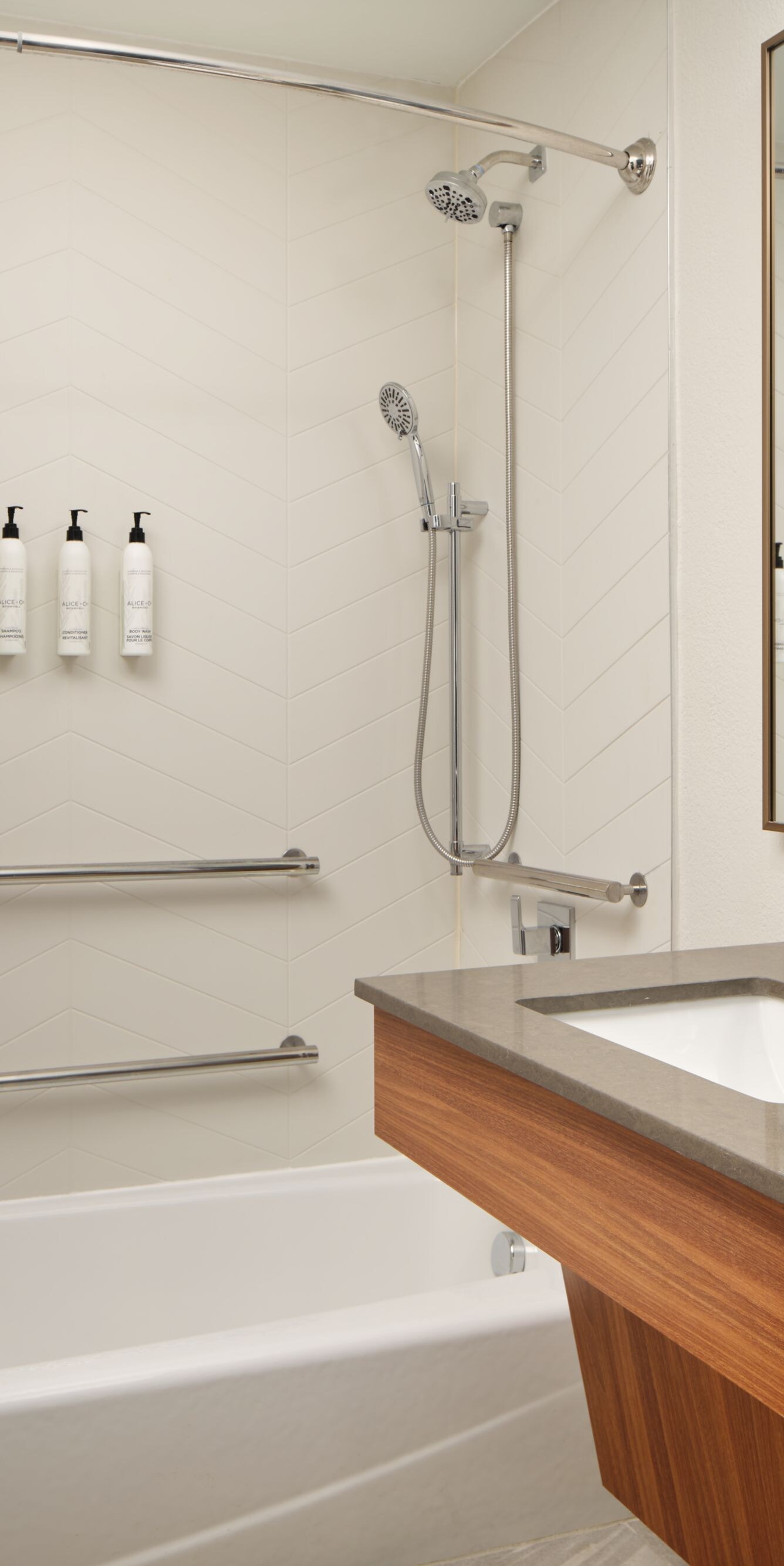 Accessible hotel bathroom with tub and vanity