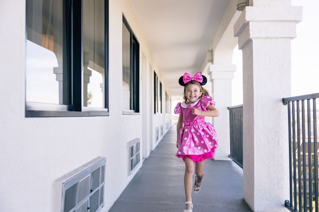 Young girl excitedly running to her room.