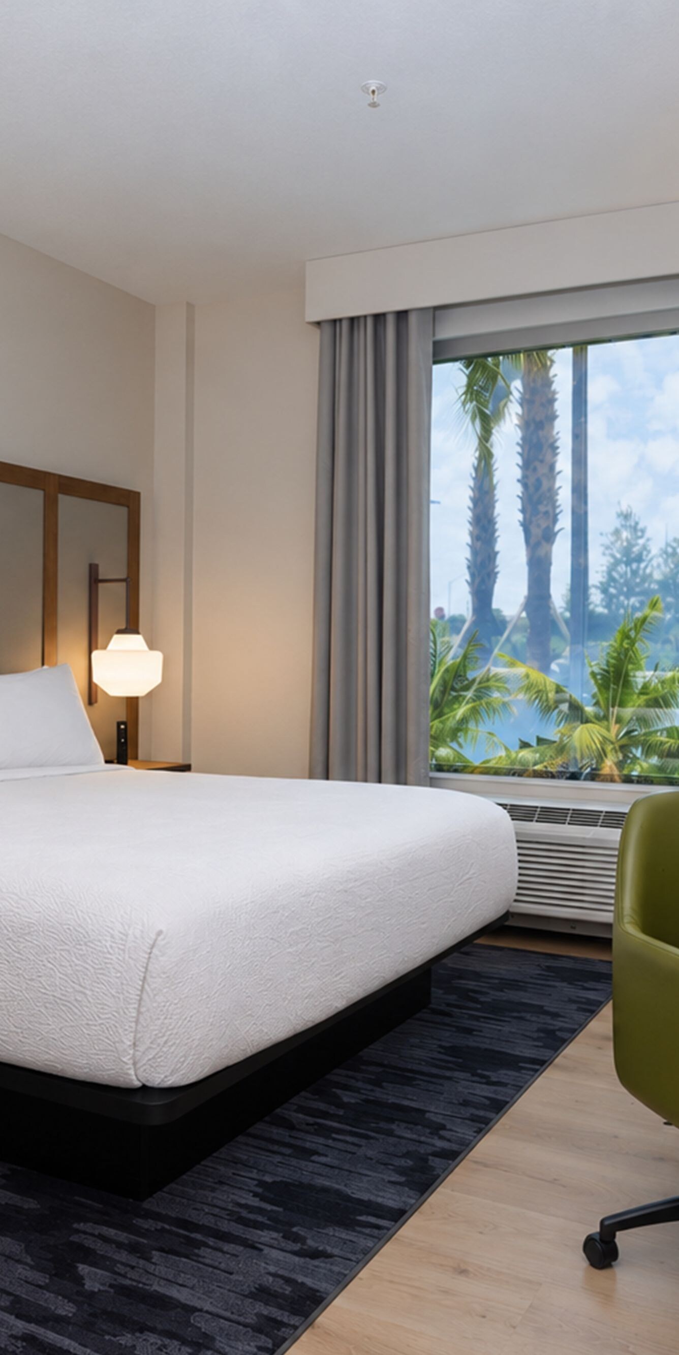 King guest room with desk and palm views