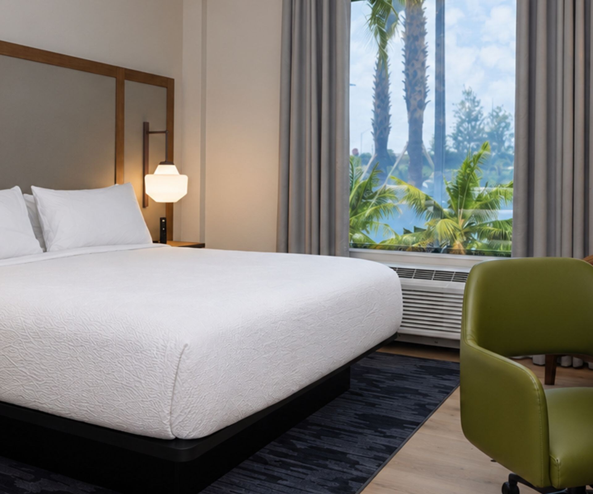 King guest room with desk and palm views