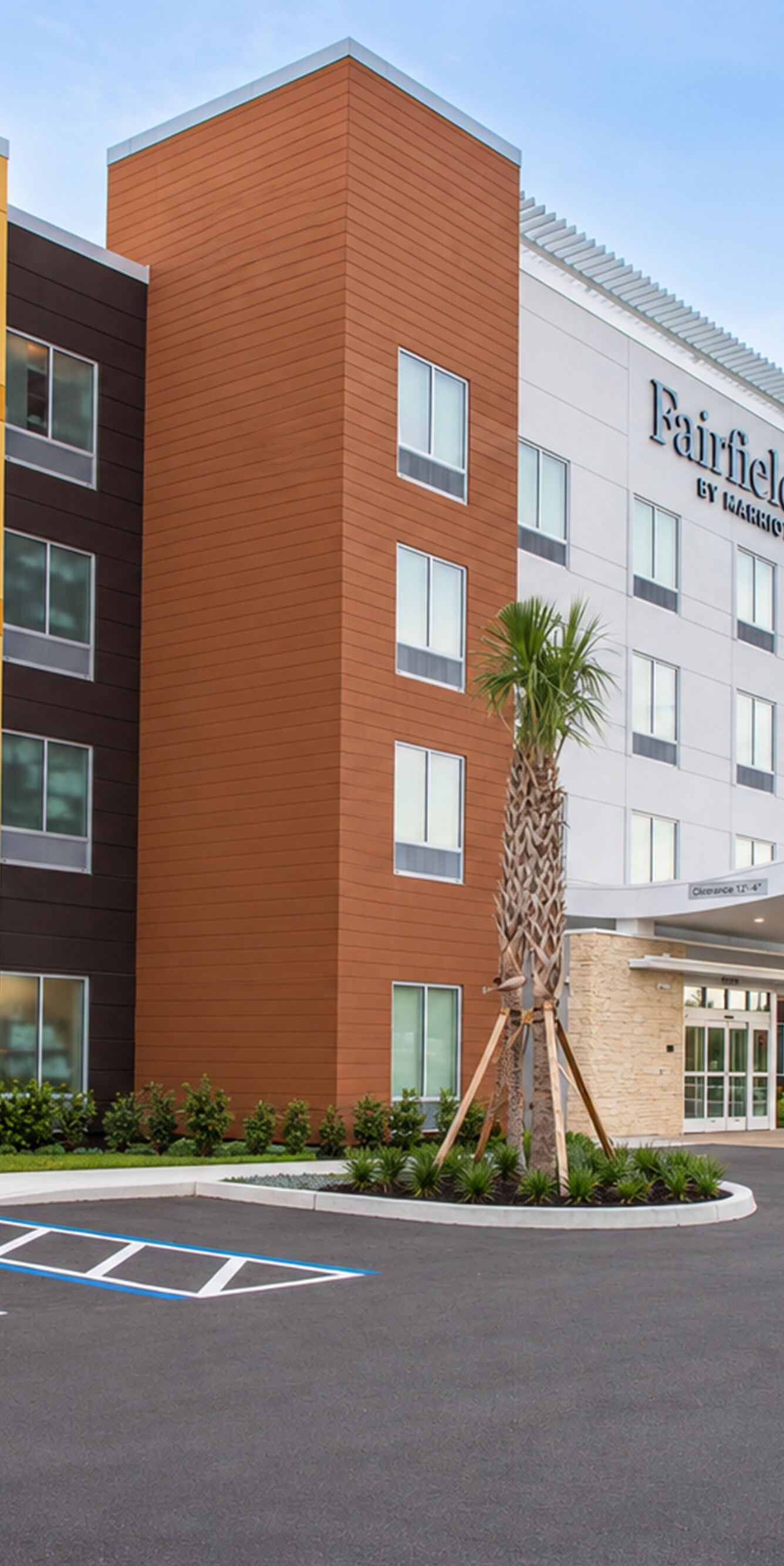 exterior with covered entrance and parking lot