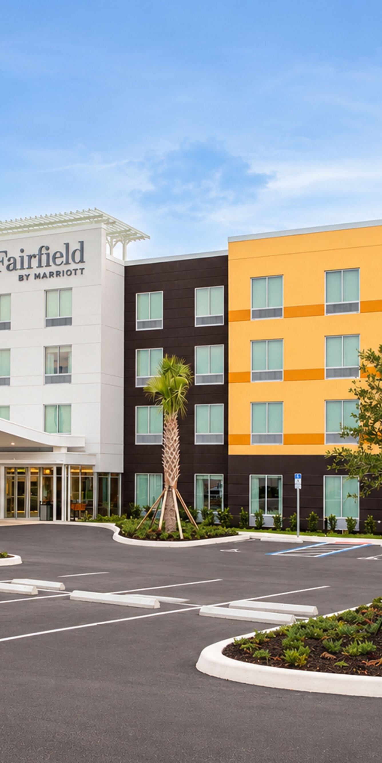Hotel exterior with entrance and parking area