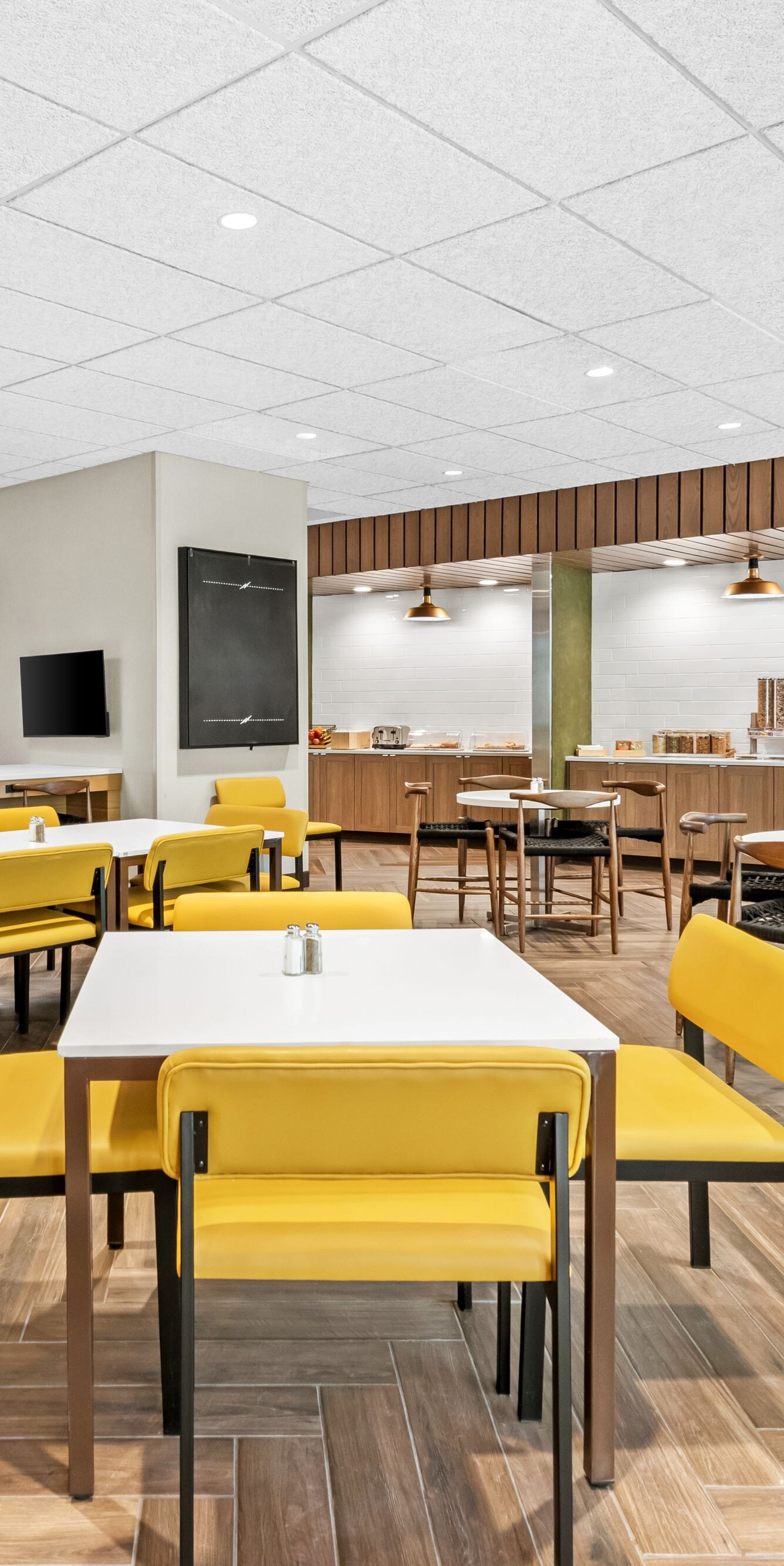 tables with yellow chairs in dining space