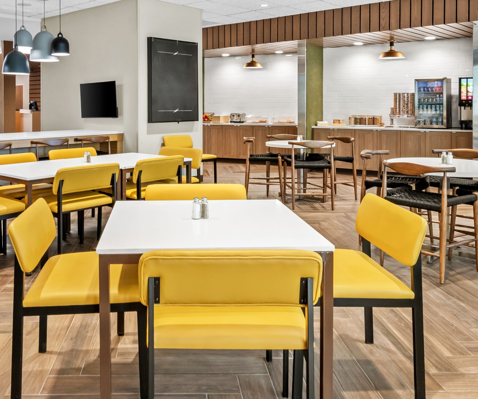 tables with yellow chairs in dining space