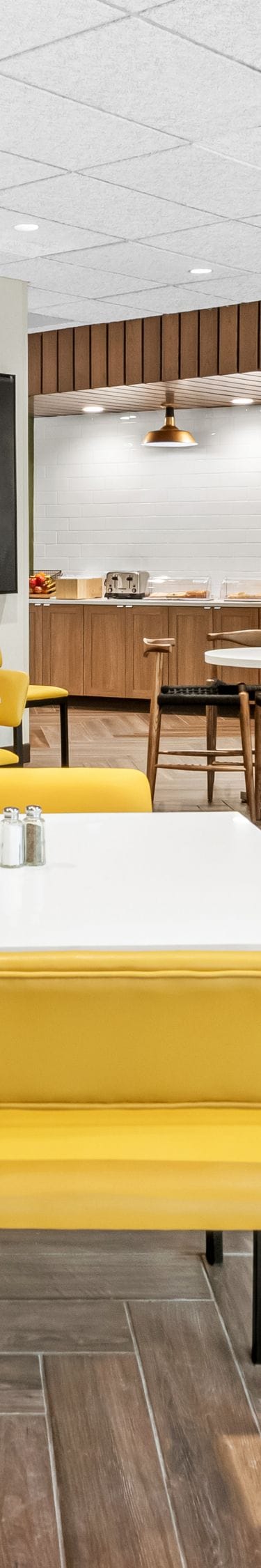 tables with yellow chairs in dining space