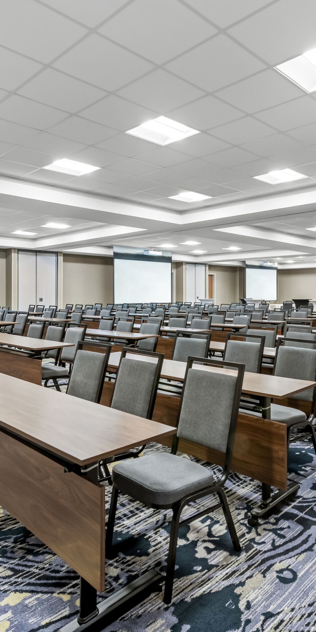 rows of tables and chairs set up like classroom