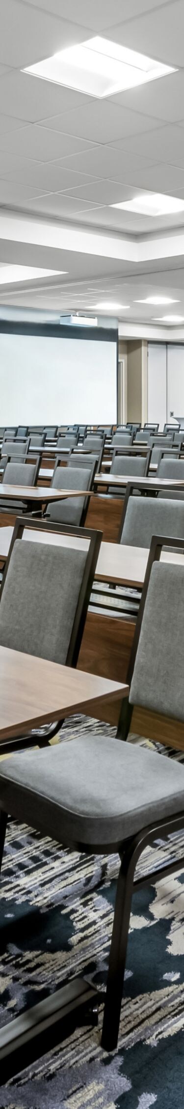 rows of tables and chairs set up like classroom