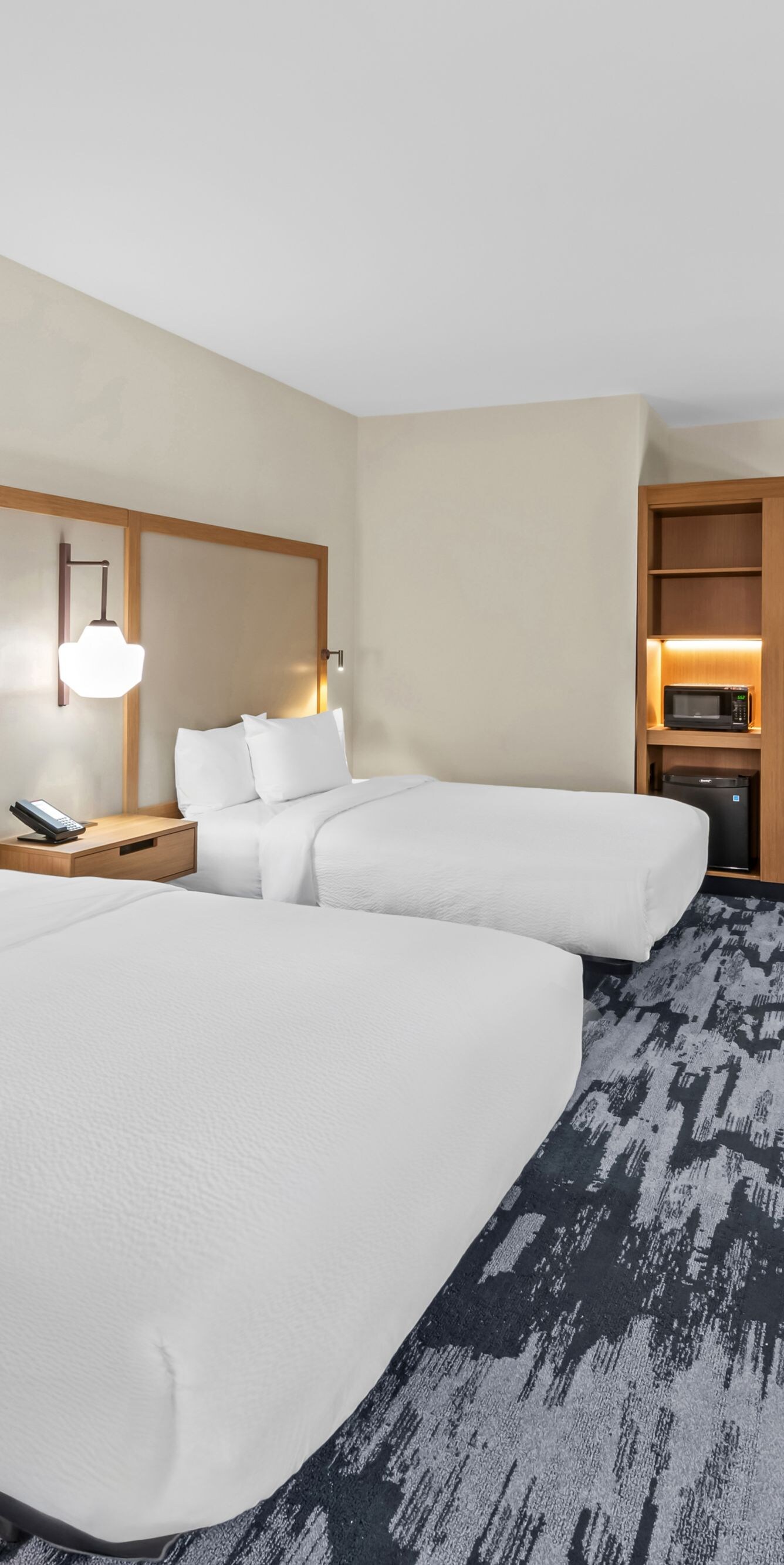 two beds, tv, microwave and mini-fridge