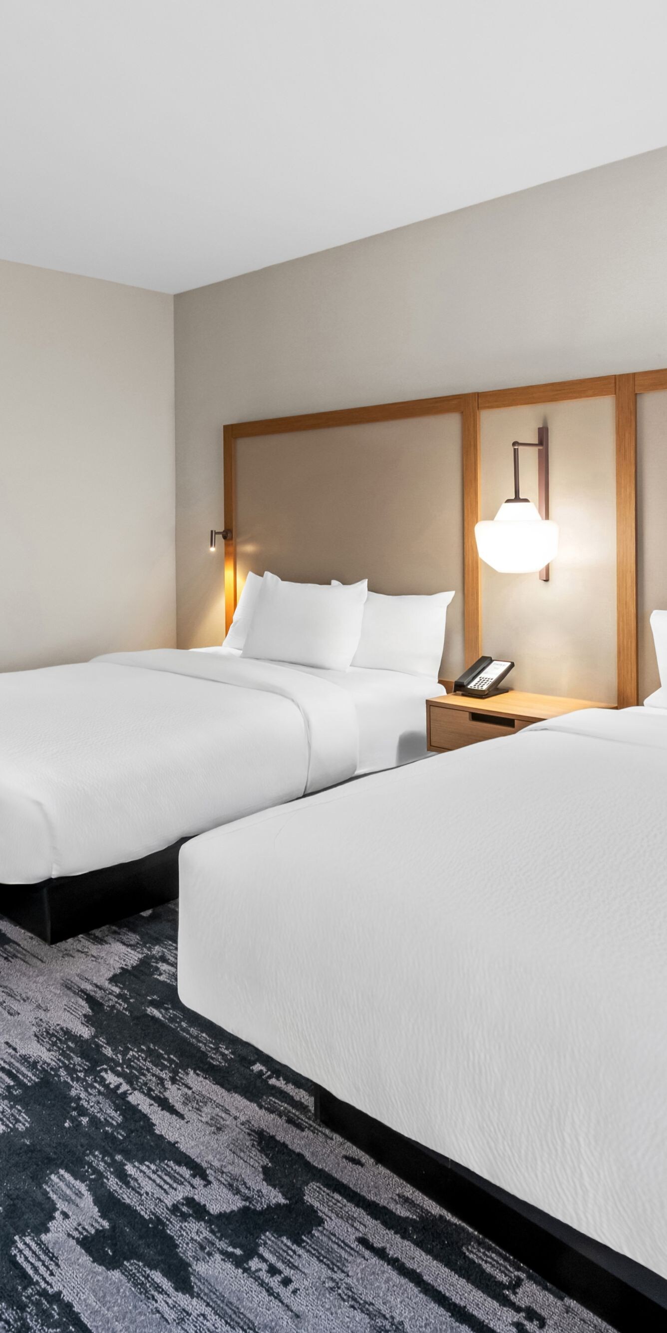 two beds, work desk, and amenities cabinet
