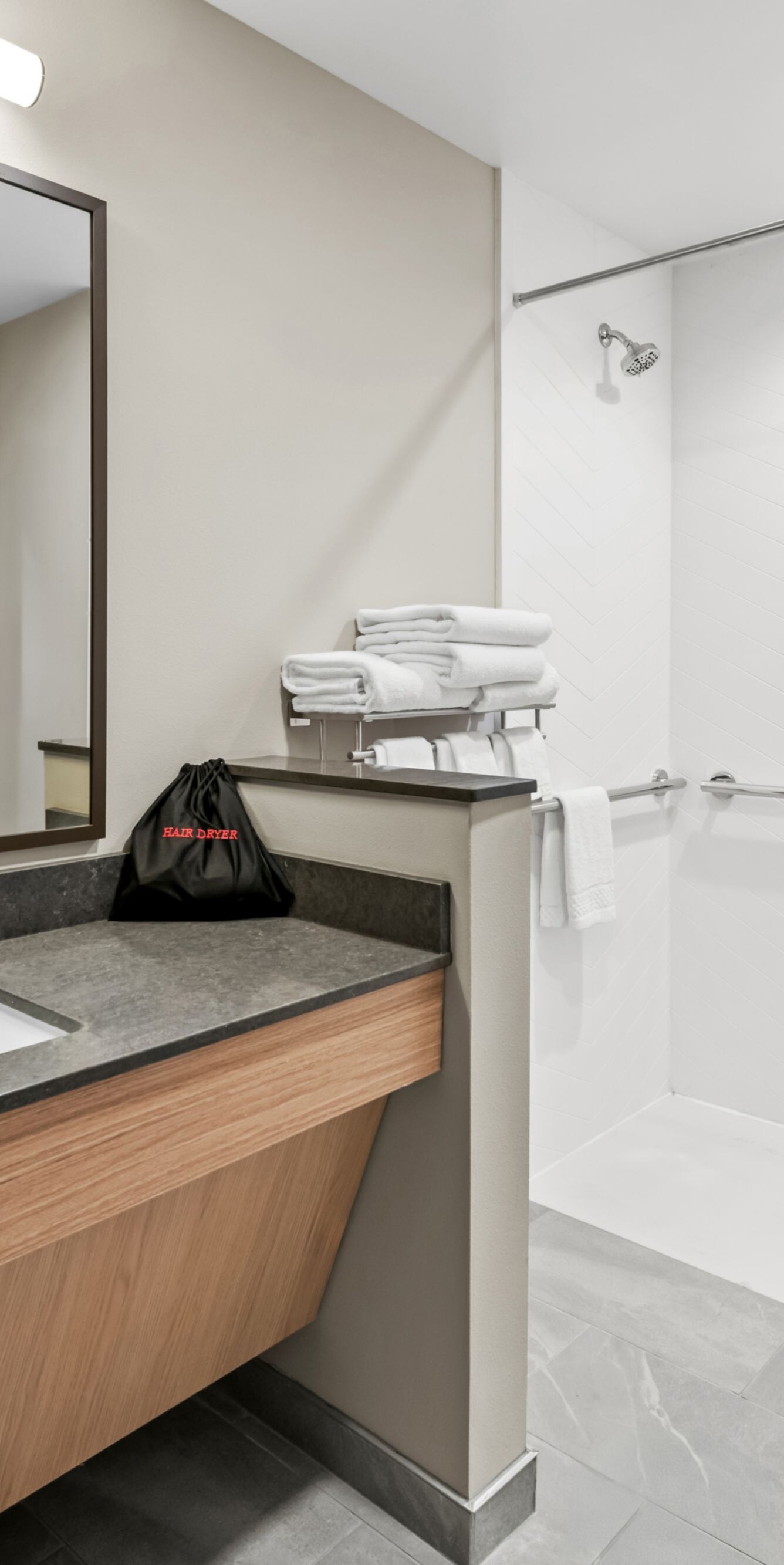 roll-in shower with grab bars, vanity