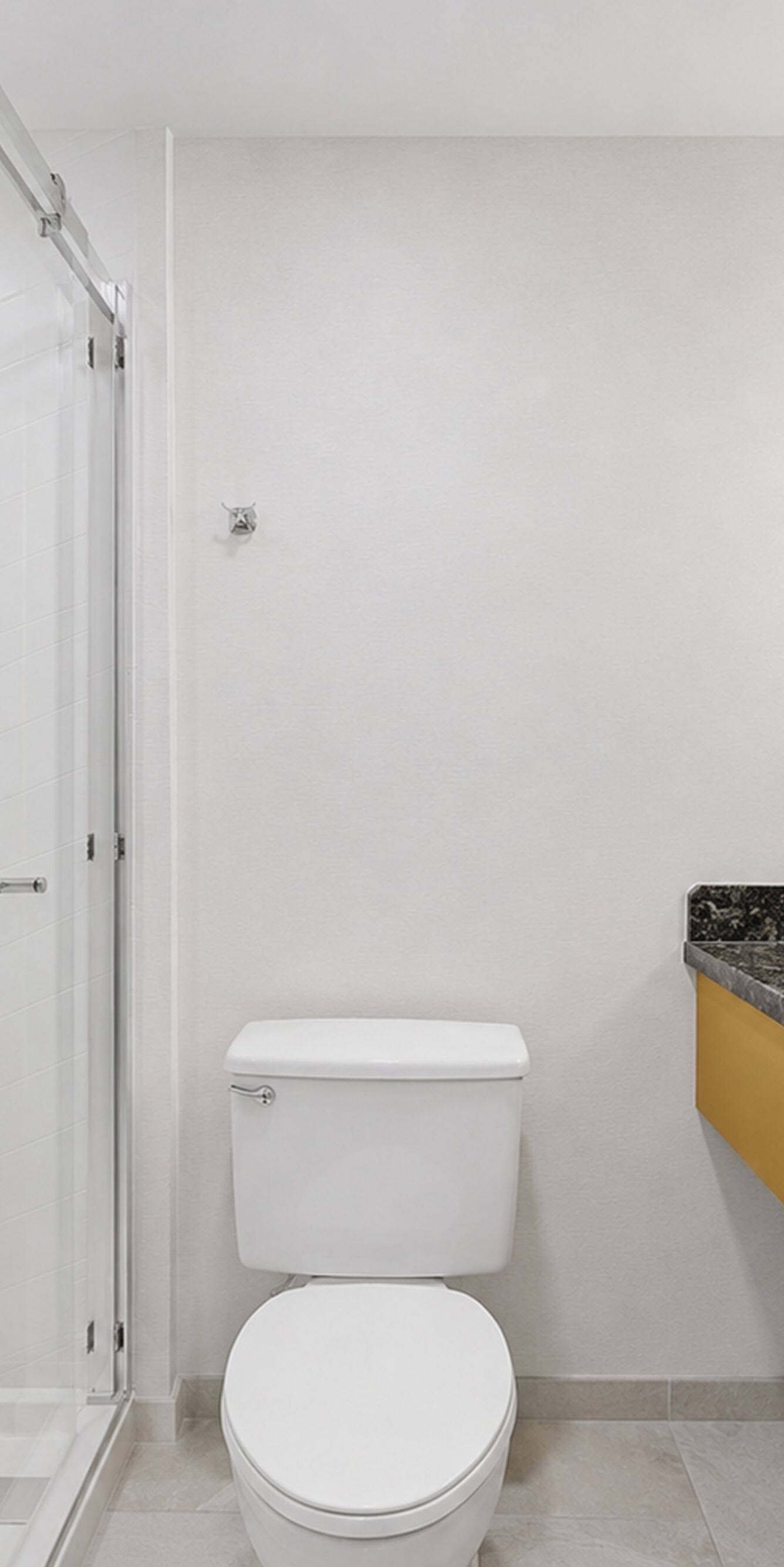 Bathroom with vanity, toilet, and glass shower