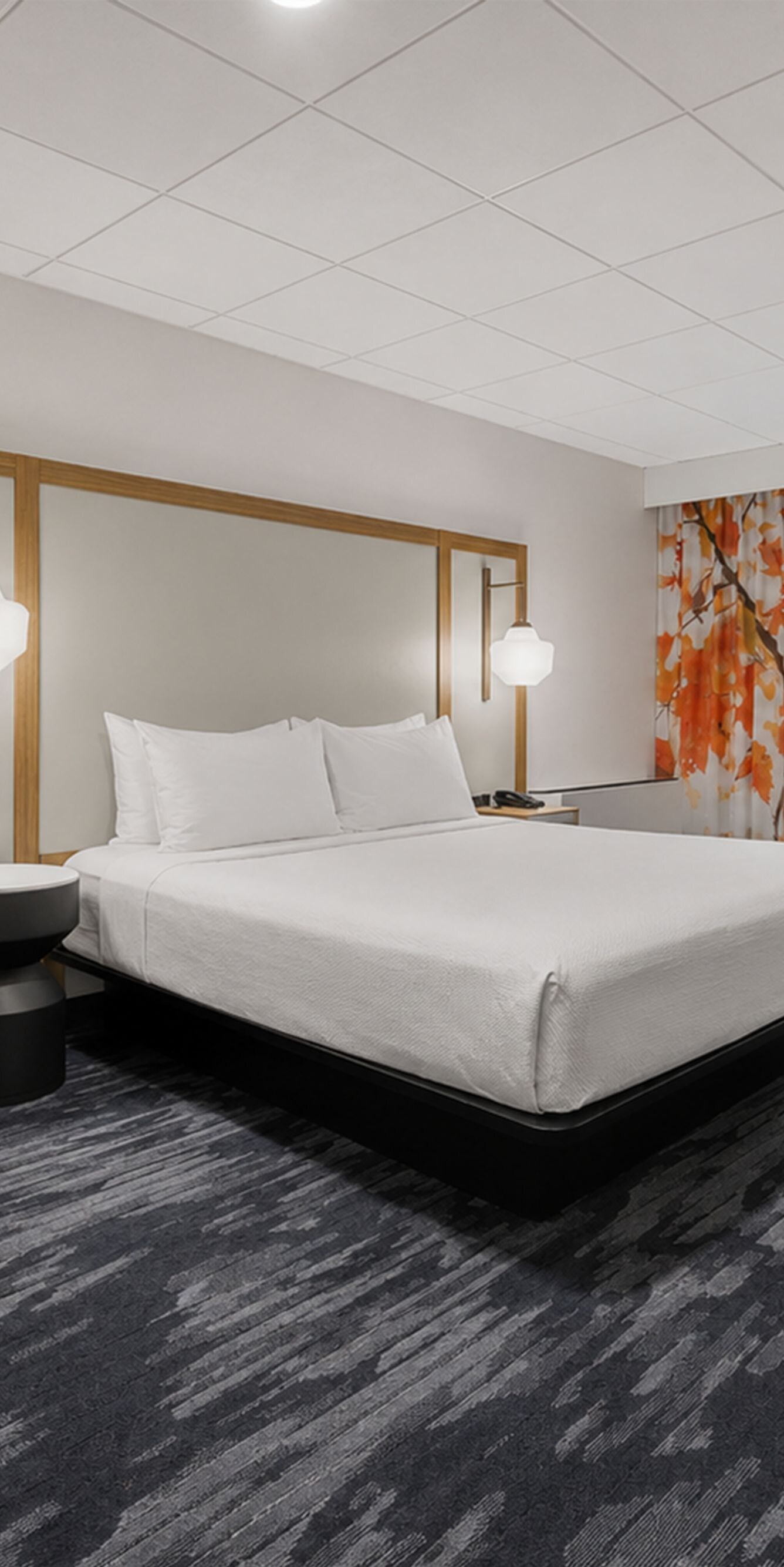 King room with bed, chair, and window view
