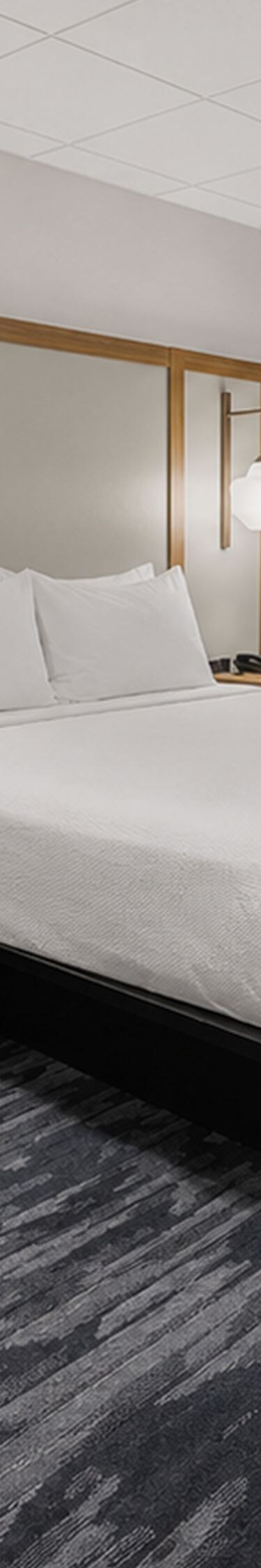 King room with bed, chair, and window view