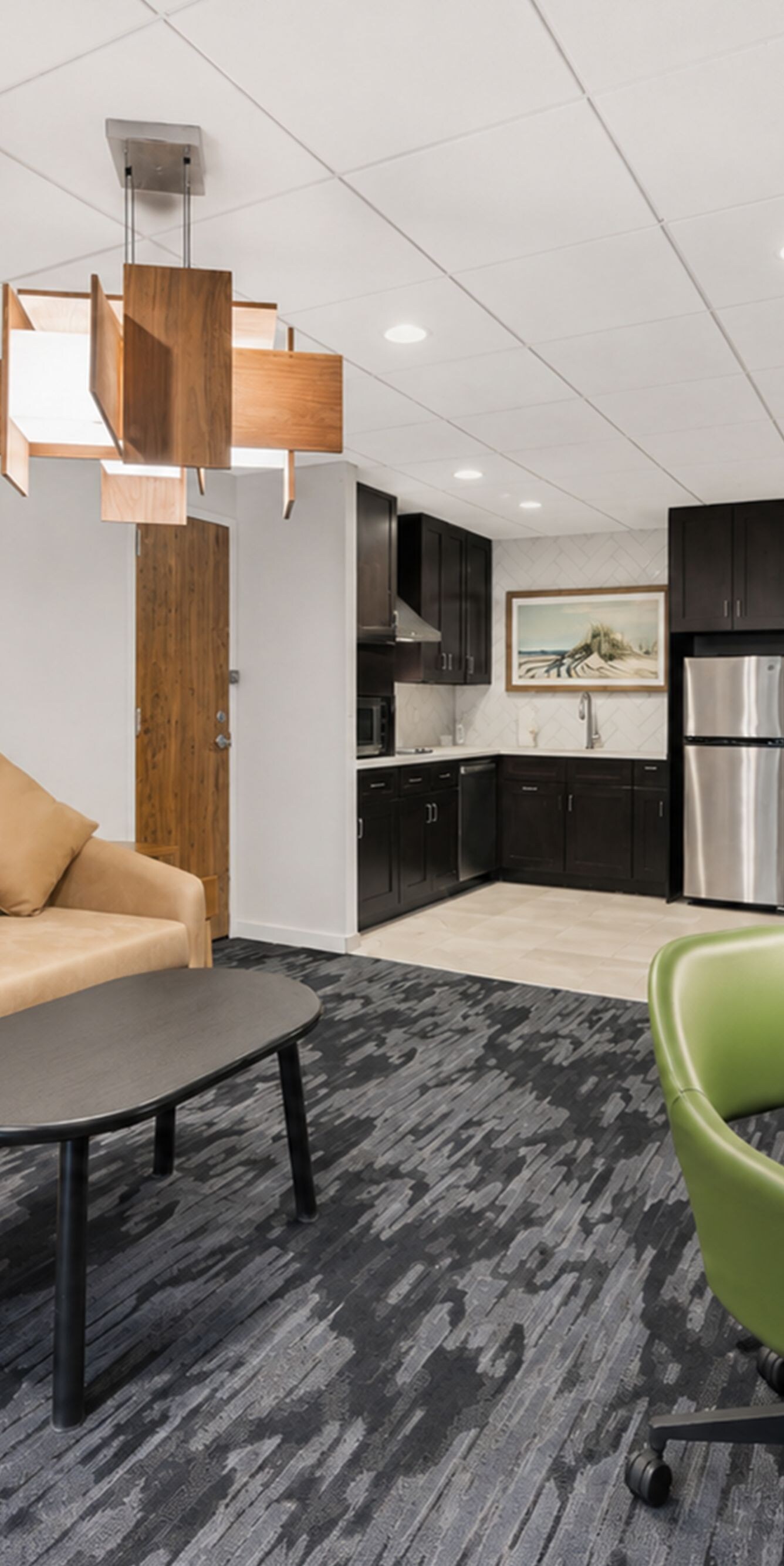 Suite living area with sofa, desk, and kitchen