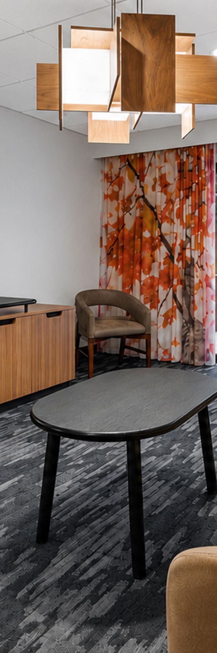 Suite living area with sofa, desk, and patio door