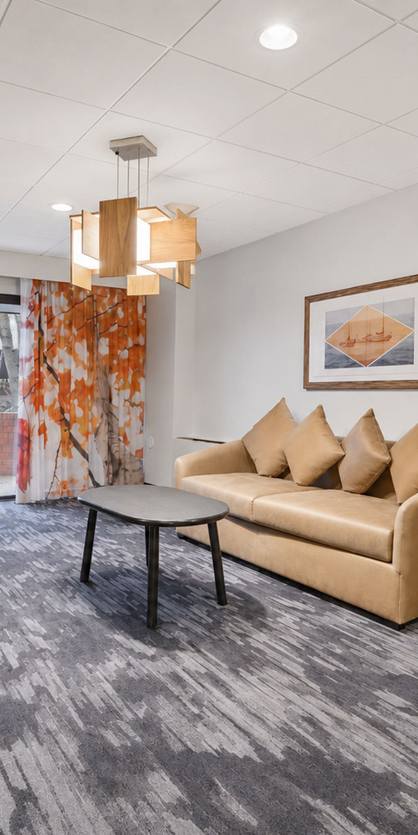 Suite living area with sofa, desk, and patio