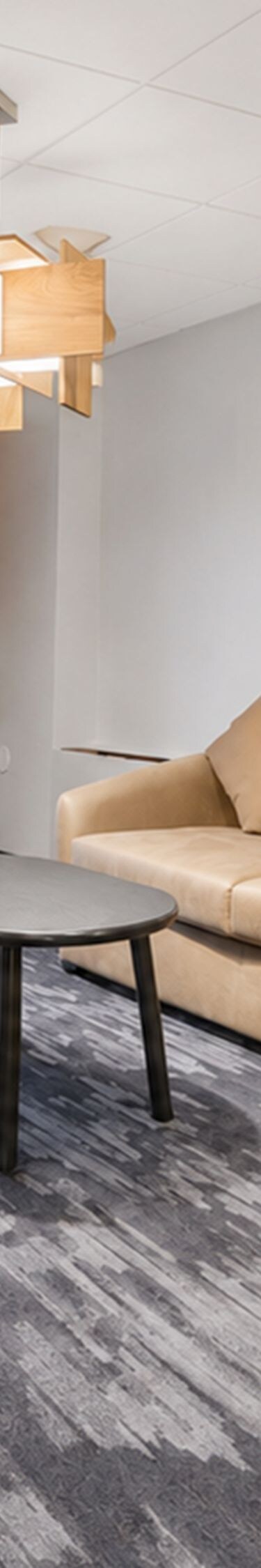 Suite living area with sofa, desk, and patio