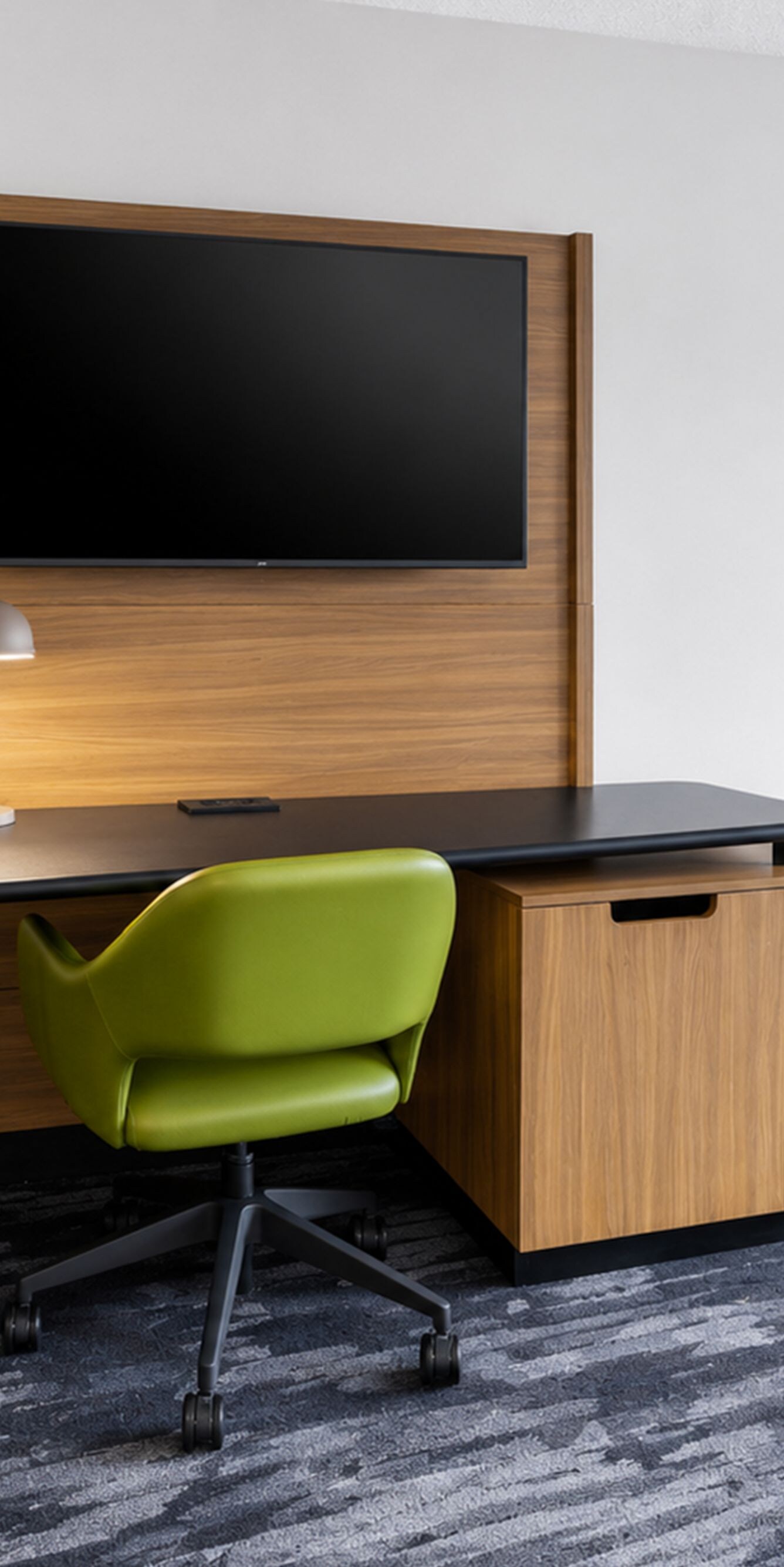Guest room workspace with desk, TV, and chair