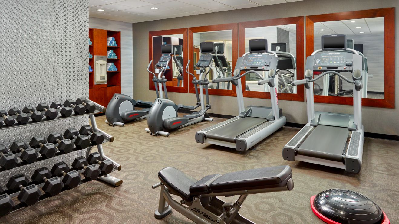 Fitness room with cardio and free weights.
