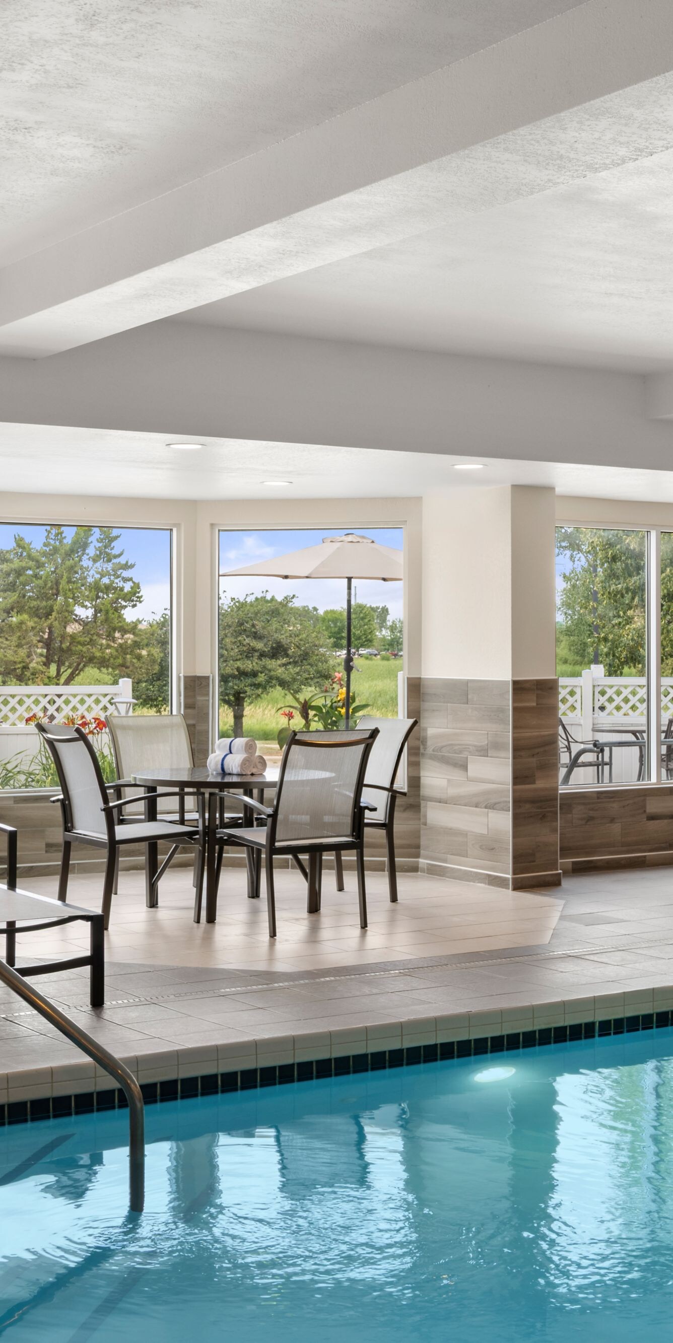 Indoor pool with lounge chairs and seating area