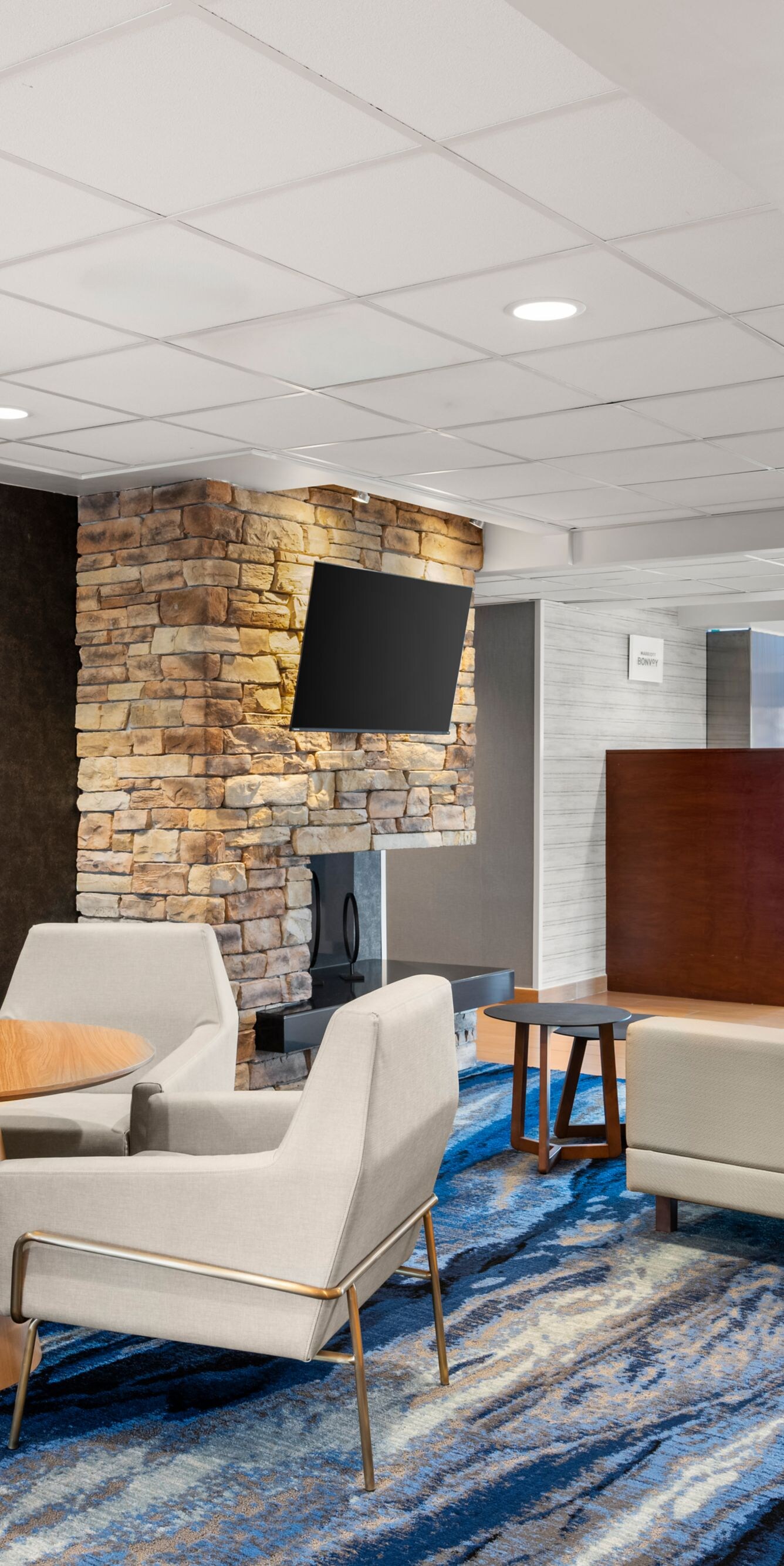 Lobby seating area with fireplace and lounge chair