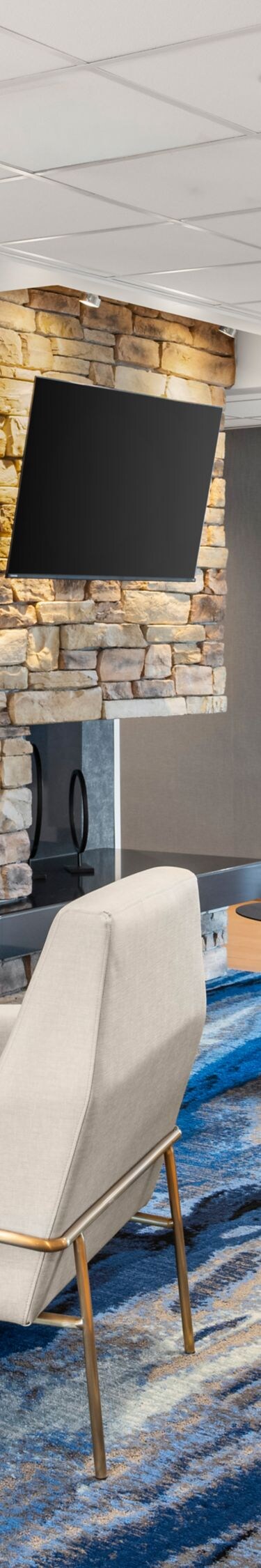 Lobby seating area with fireplace and lounge chair