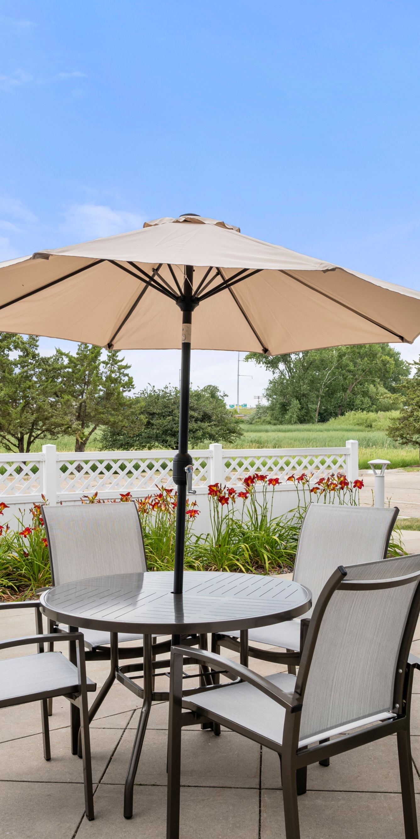 Outdoor patio with table, chairs, and umbrella