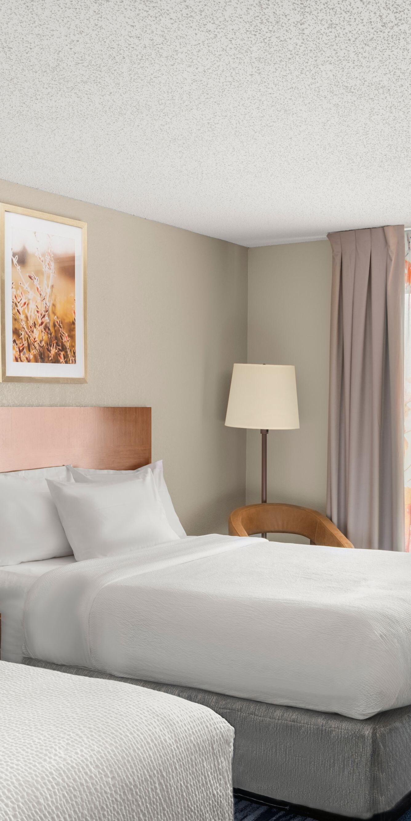two beds, nightstands, lamps, and desk