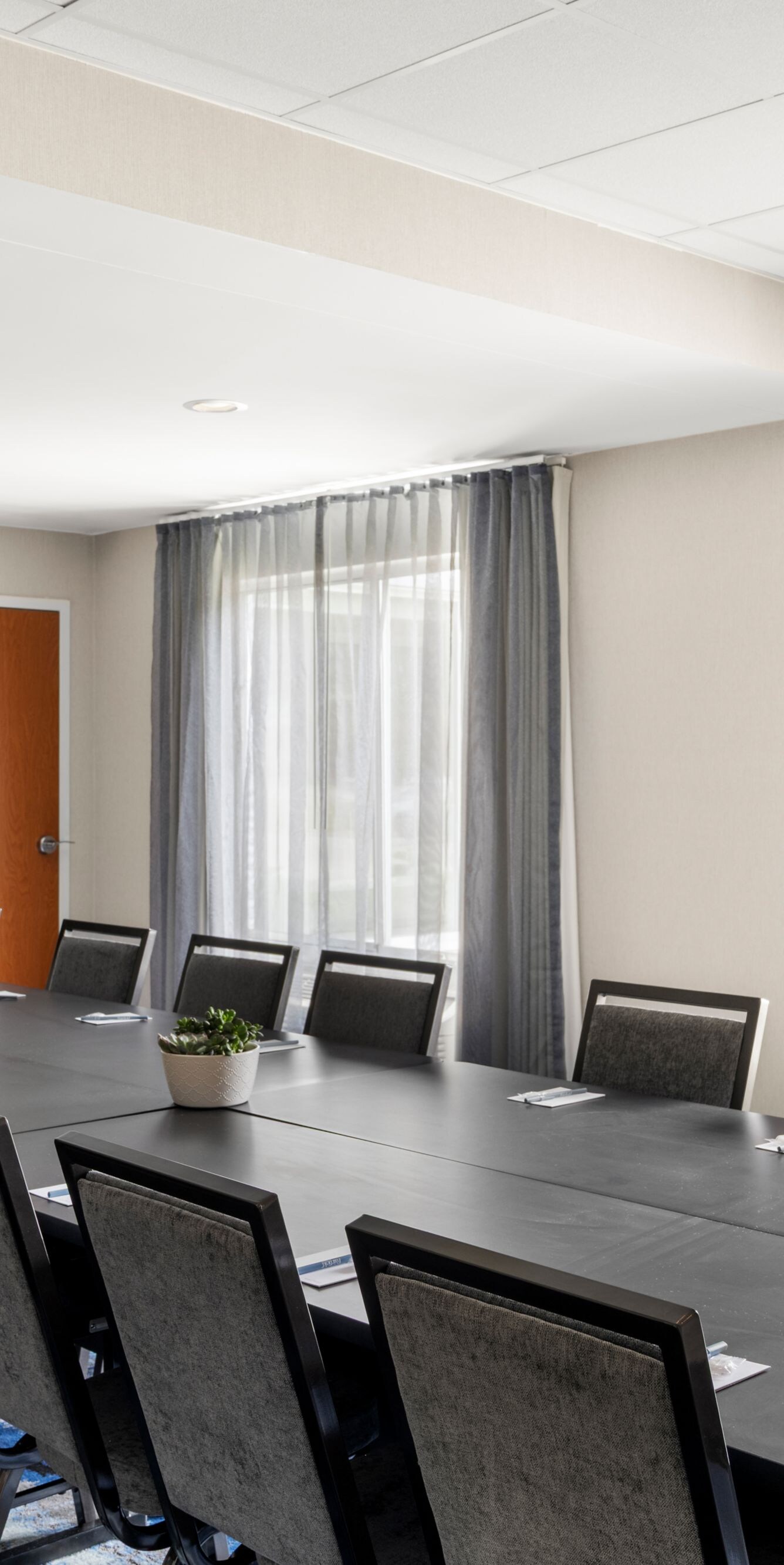 Boardroom with conference tables and TV screen