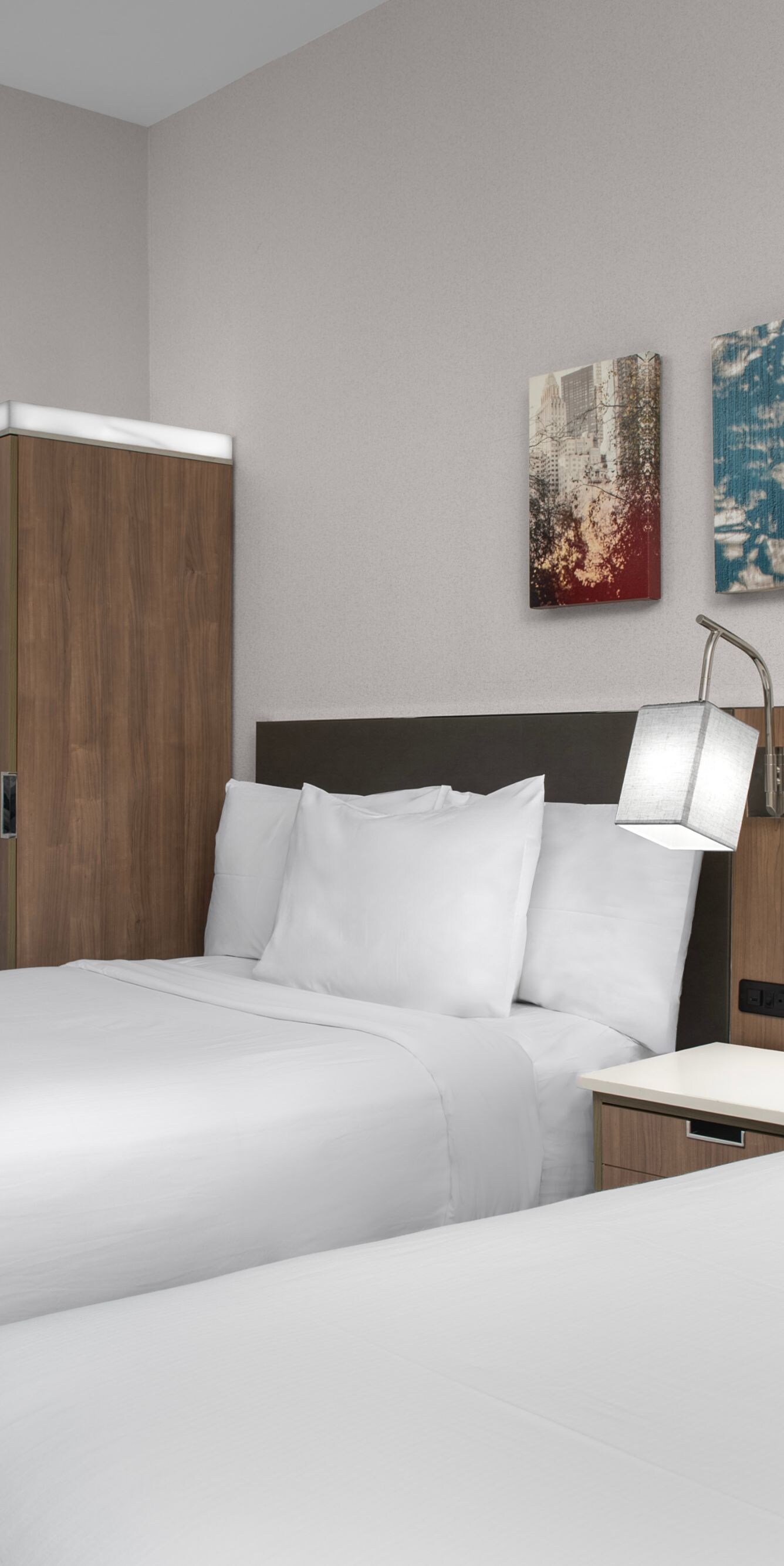 two queen beds with nightstand and lights between