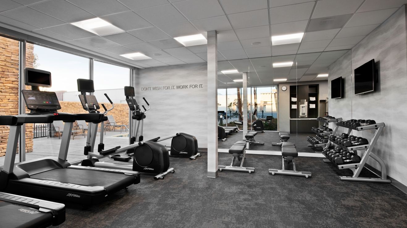 Fitness Center with cardio equipment and dumbbells
