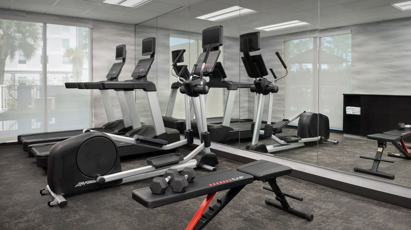fitness room with treadmils and weights