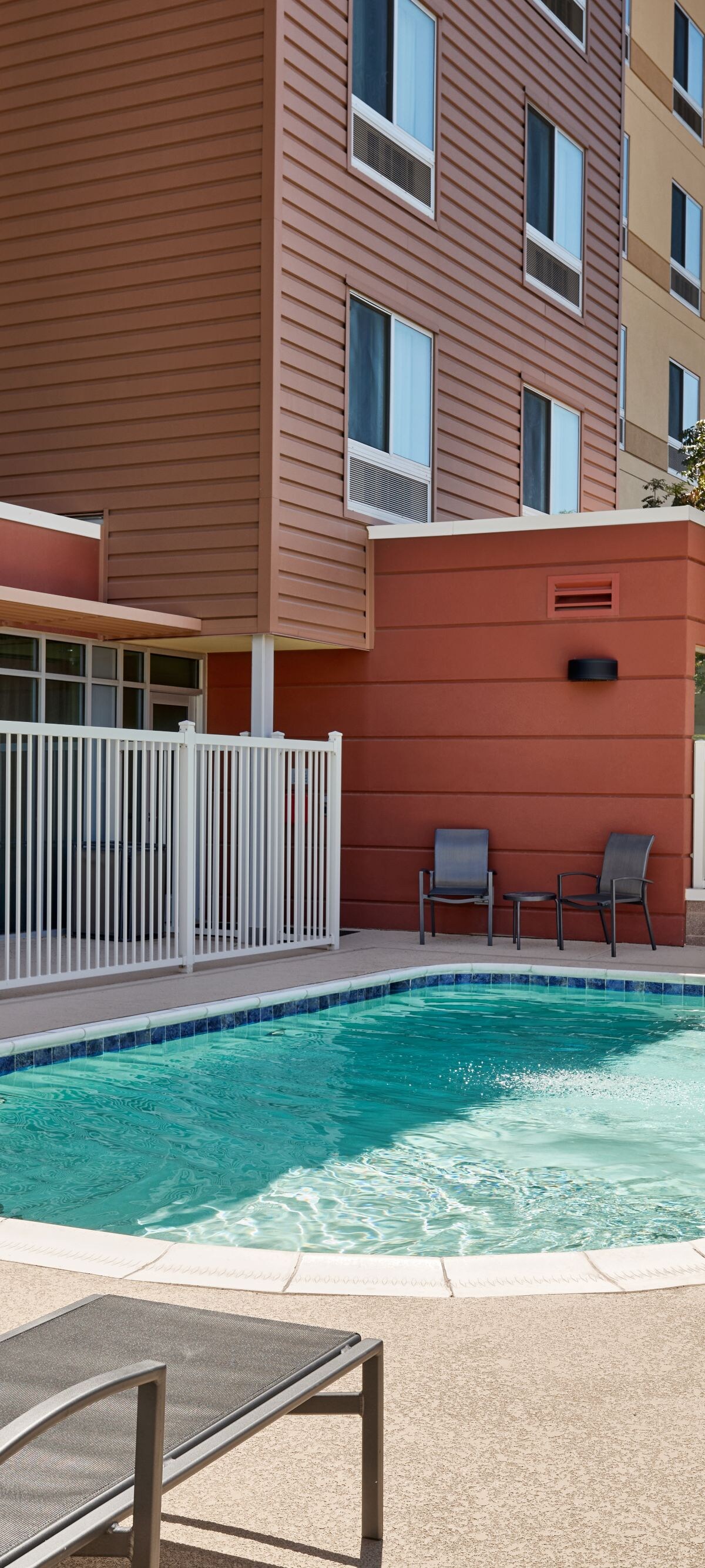 Outdoor pool with lounge chairs and lift
