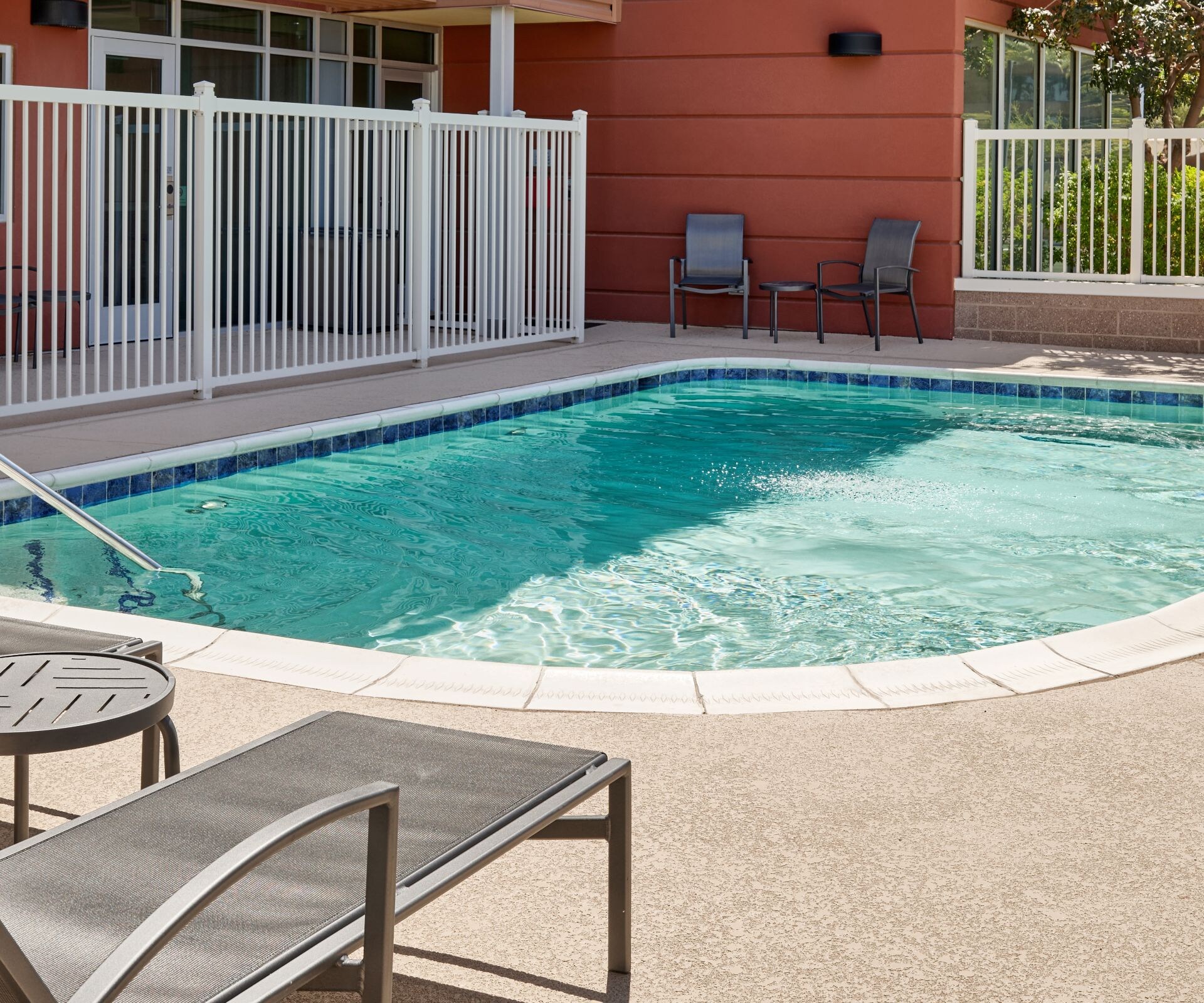 Outdoor pool with lounge chairs and lift
